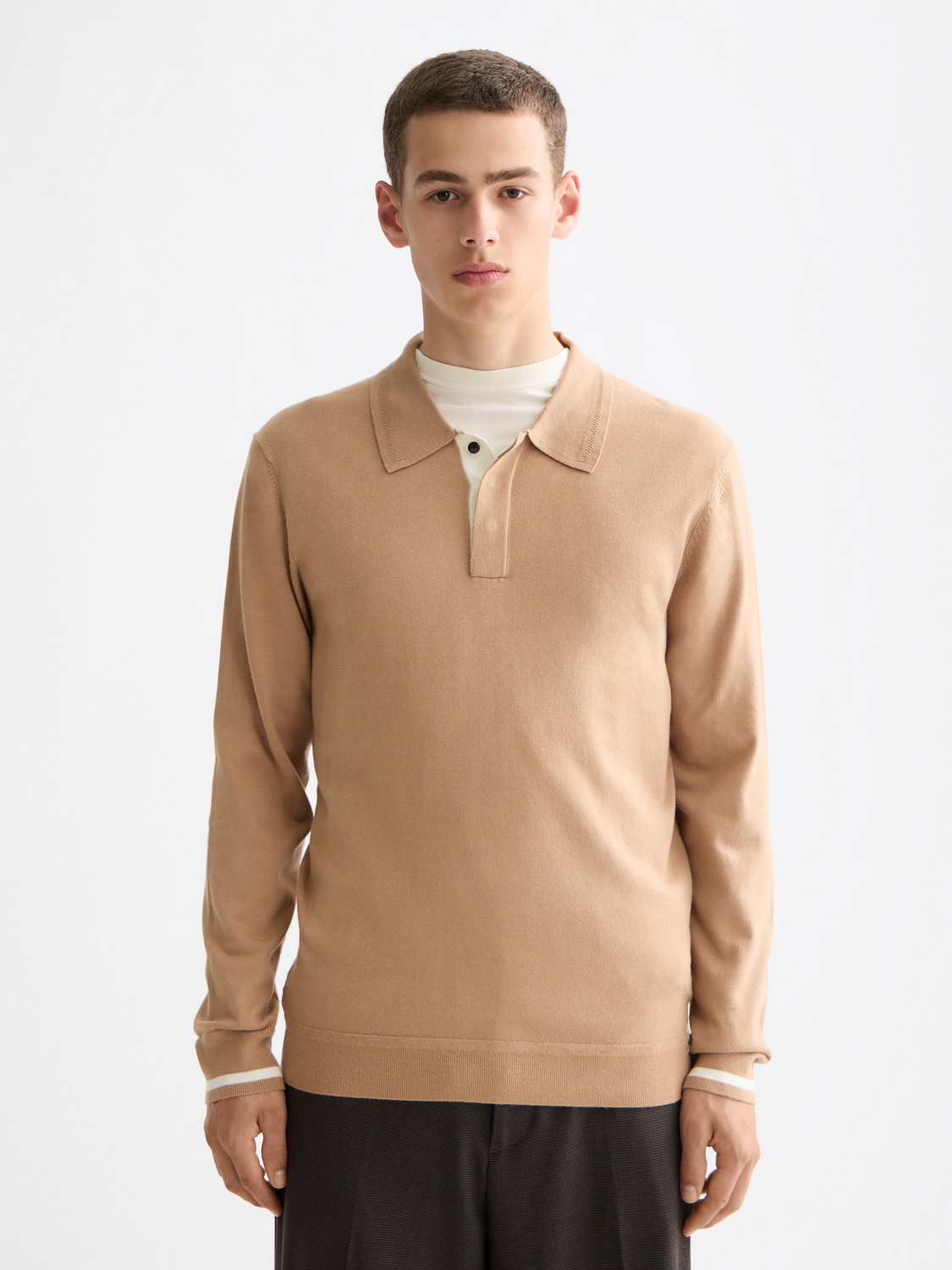 Knitted long-sleeved polo shirt by Scotch & Soda featuring a classic collar and textured fabric in a deep red color.