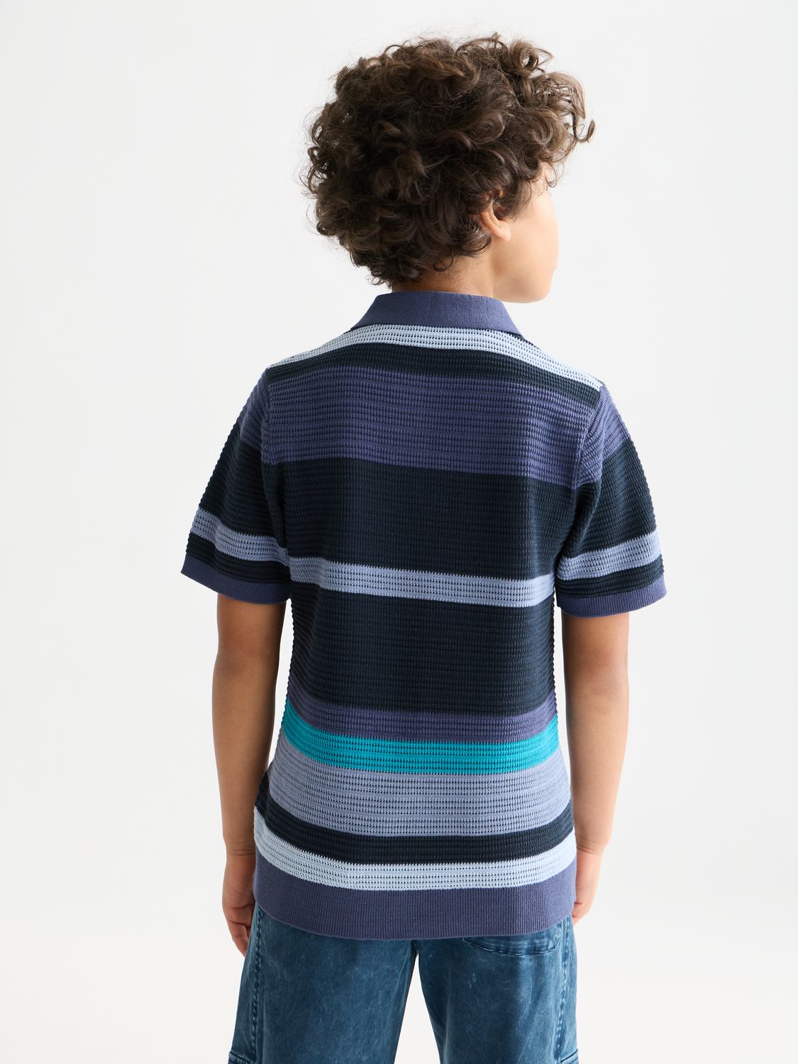 Kids striped knitted polo shirt by Scotch & Soda, featuring a classic design with colorful stripes and a collar, back view.