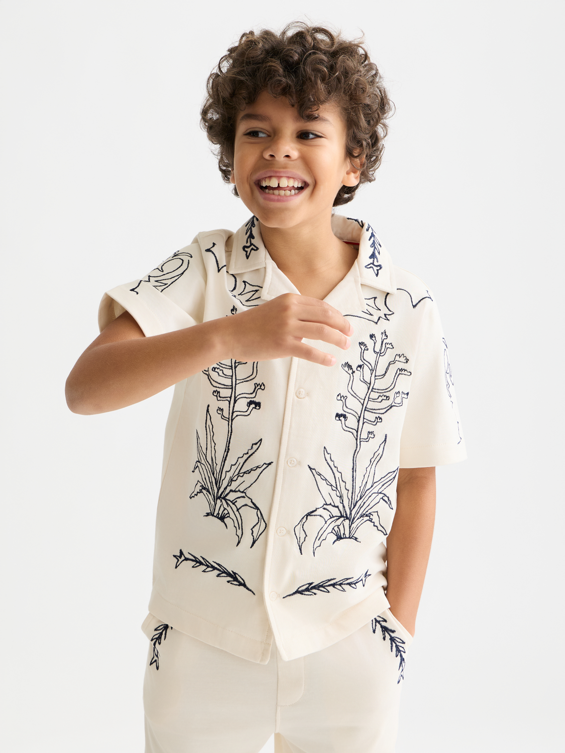 Kids' printed short-sleeved shirt by Scotch & Soda featuring colorful patterns and a classic fit, displayed on a white background.