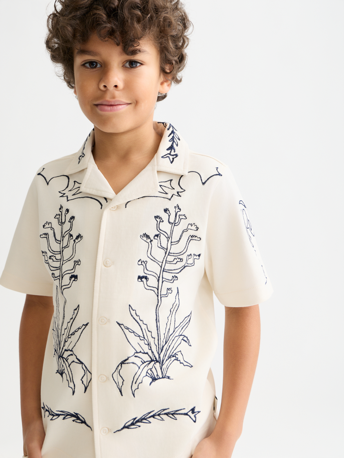 Kids' printed short-sleeved shirt by Scotch & Soda, colorful design, lightweight cotton fabric, casual summer wear.
