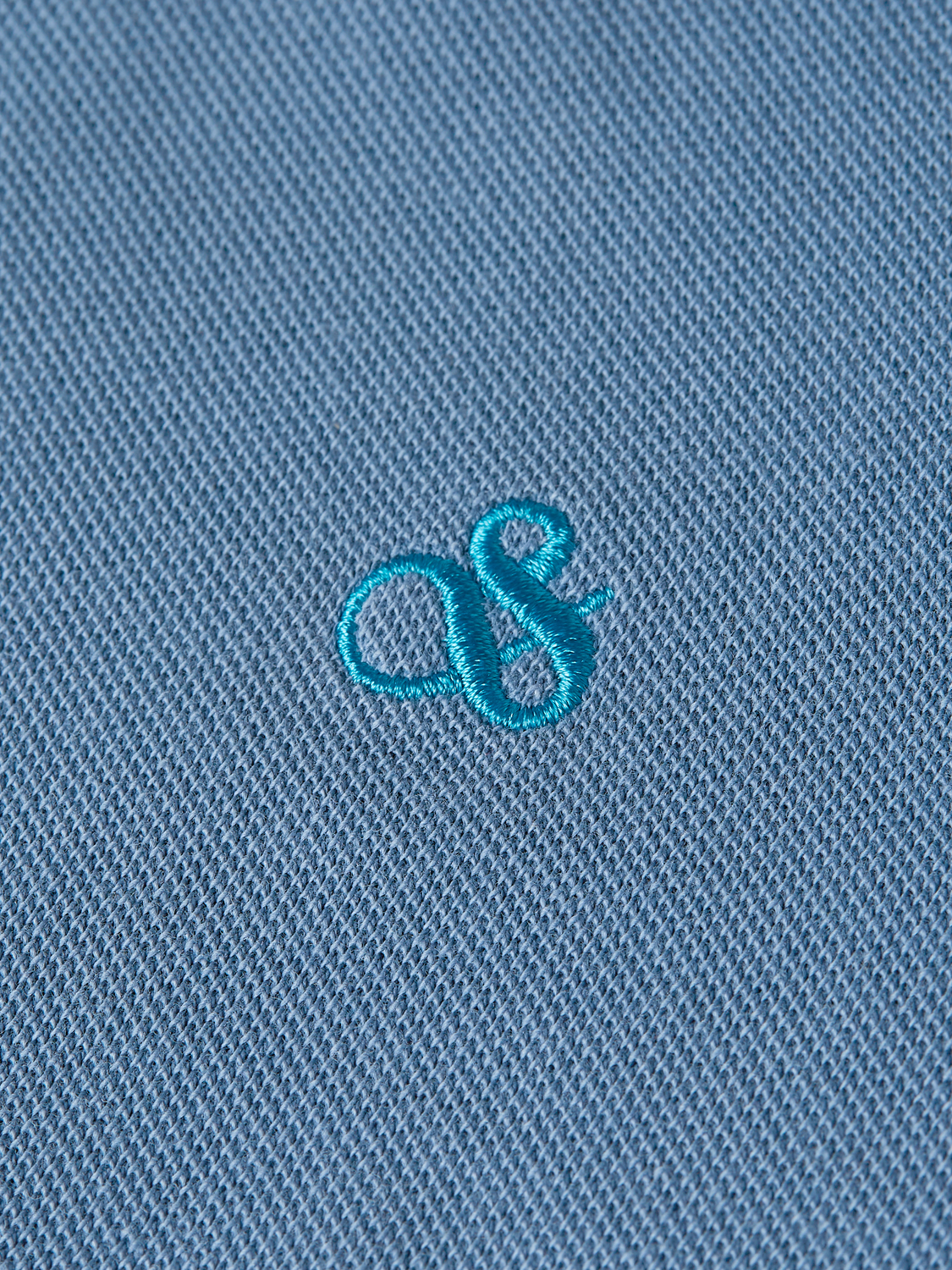 Kids' garment-dyed pique polo shirt by Scotch & Soda, featuring a classic collar and short sleeves in vibrant colors.