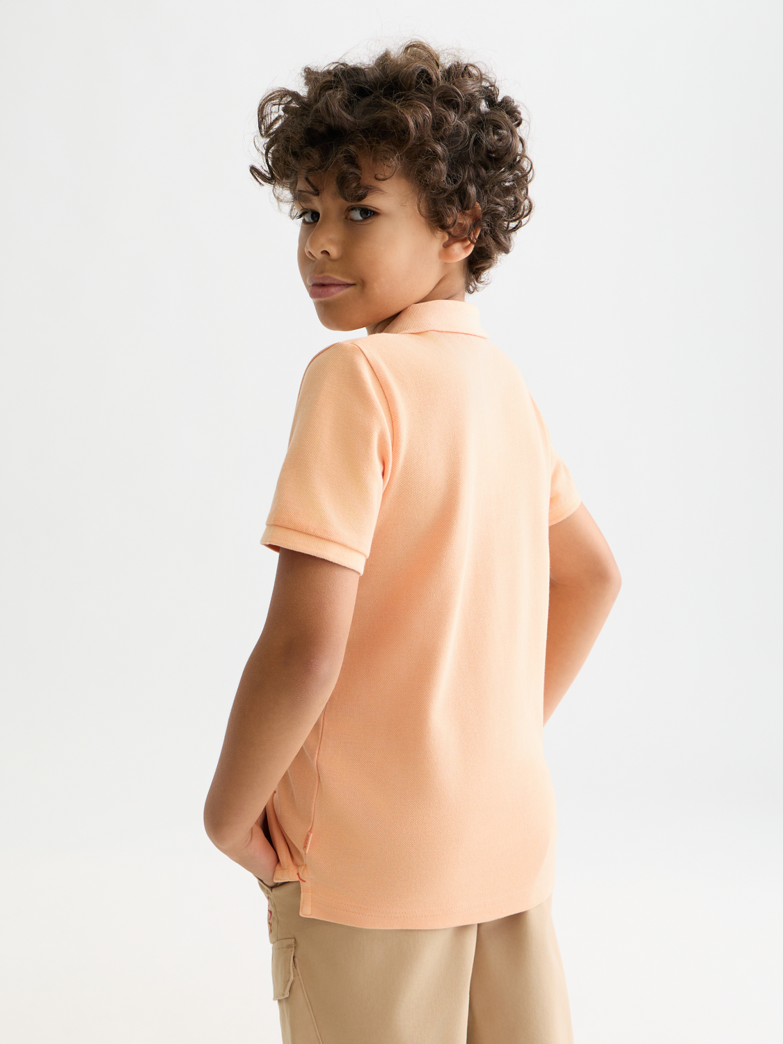 Kids garment-dyed pique polo shirt by Scotch & Soda, showing the back view with collar and short sleeves.