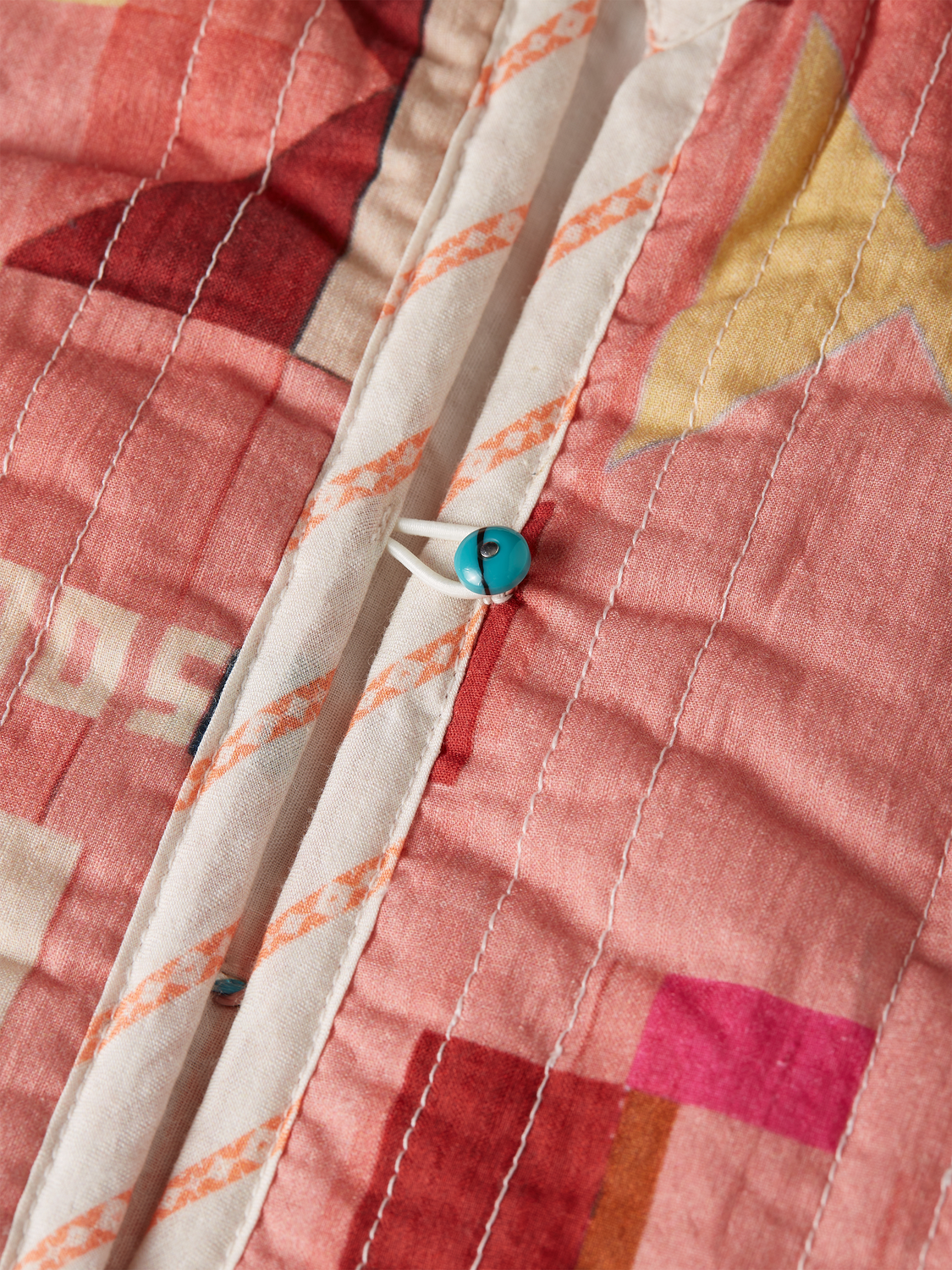 Kids' reversible gilet by Scotch & Soda, showing the stylish side with color accents and the plain side in a cozy fabric.