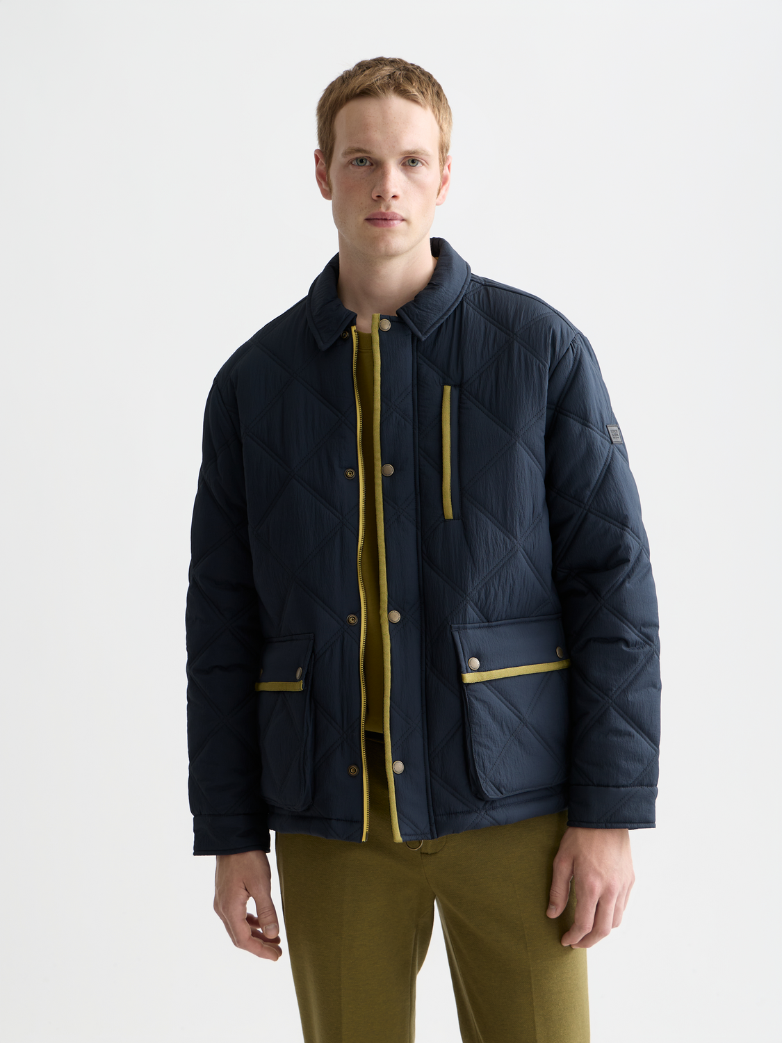 Scotch & Soda quilted jacket with a stand collar and front zipper, featuring a textured quilted pattern in a versatile color.
