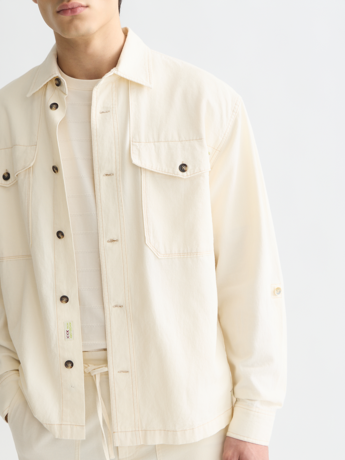 Cotton-linen overshirt jacket by Scotch & Soda in a neutral color, showing a relaxed fit and textured fabric.