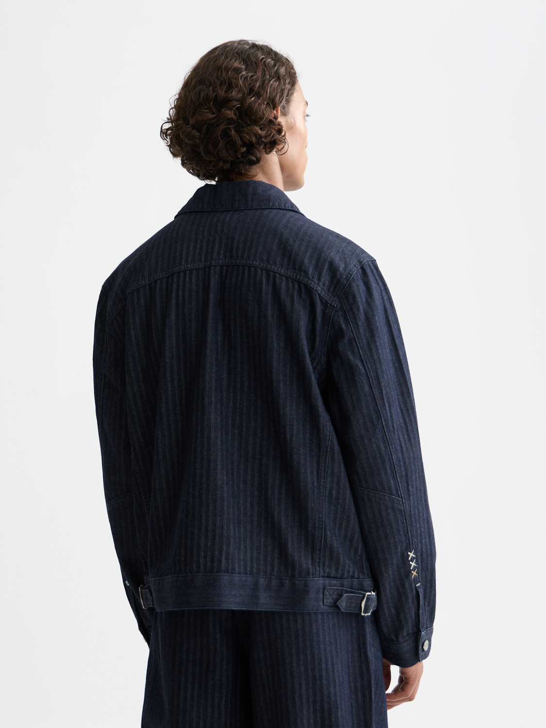 Scotch & Soda trucker jacket in denim with button front and classic collar, shown from the back.