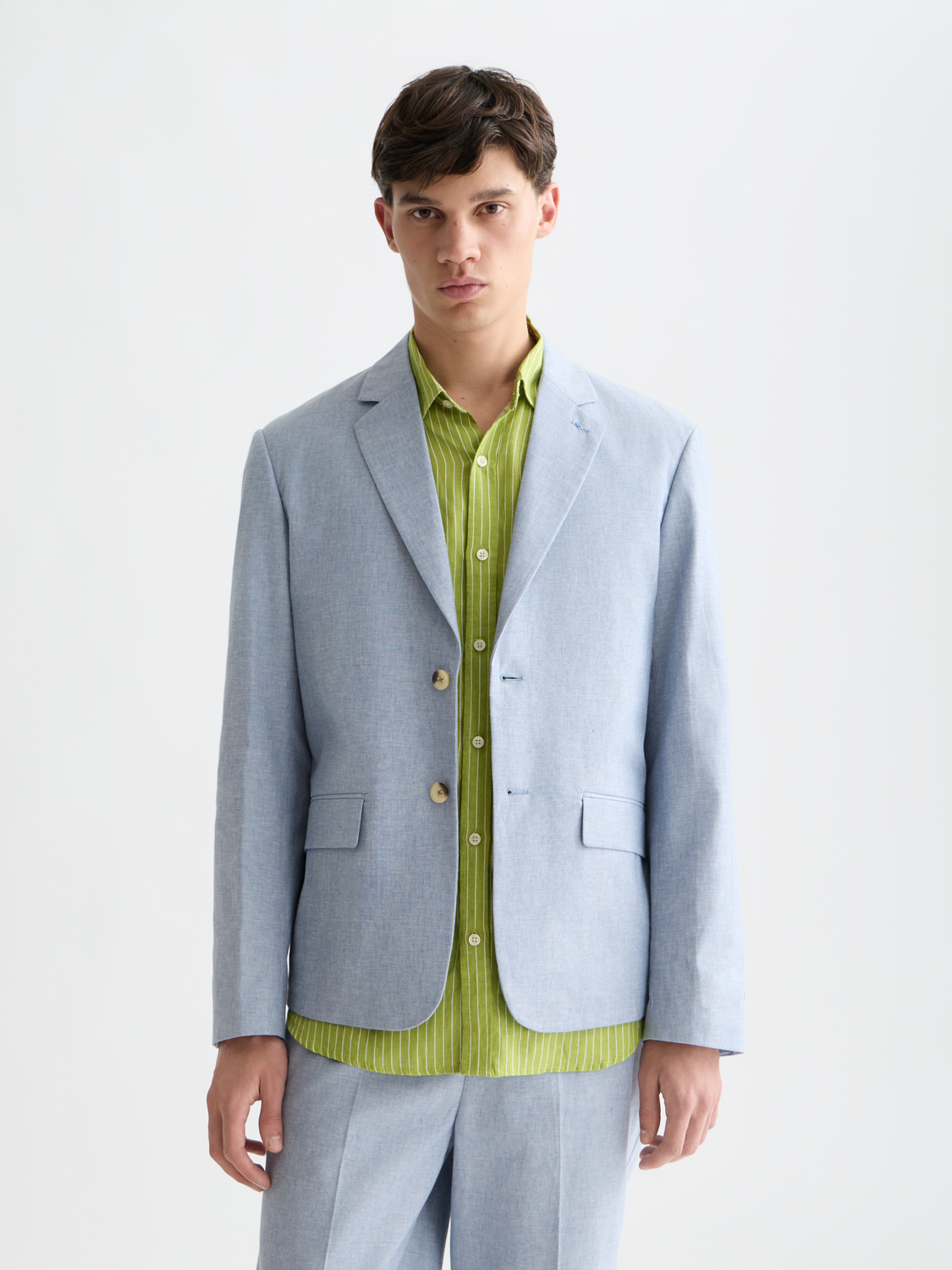 Unconstructed Scotch & Soda blazer in light fabric with a tailored fit, shown on a hanger against a neutral background.
