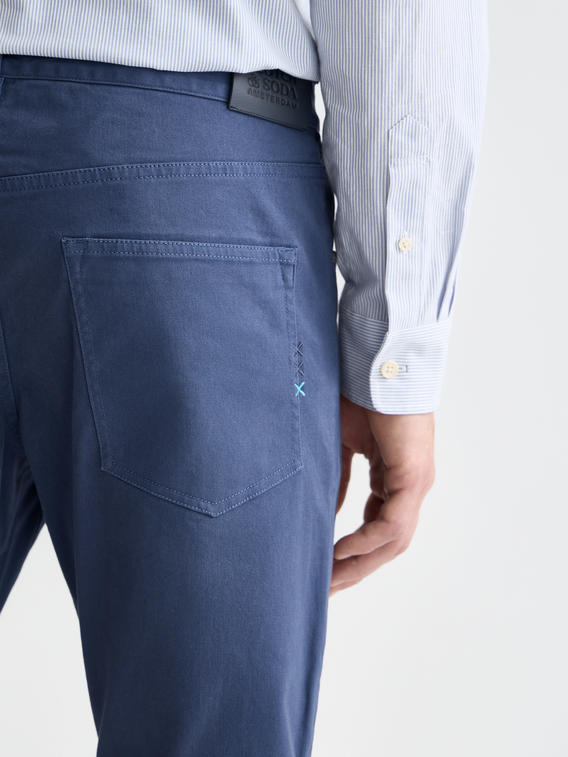 Slim-fit Ralston pants by Scotch & Soda, shown in dark fabric, with front pockets and tailored fit for a modern, stylish look.