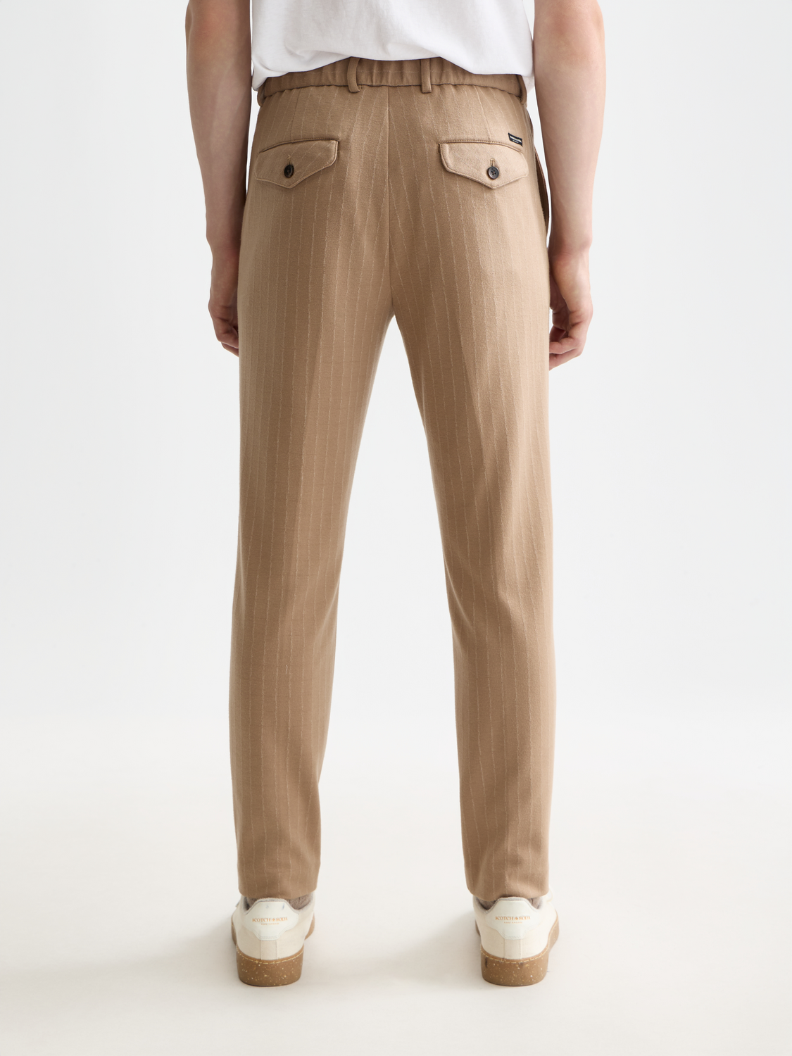 SCOTCH & SODA Finch tapered-fit pants shown from the back in dark fabric with a tailored fit and clean stitching.