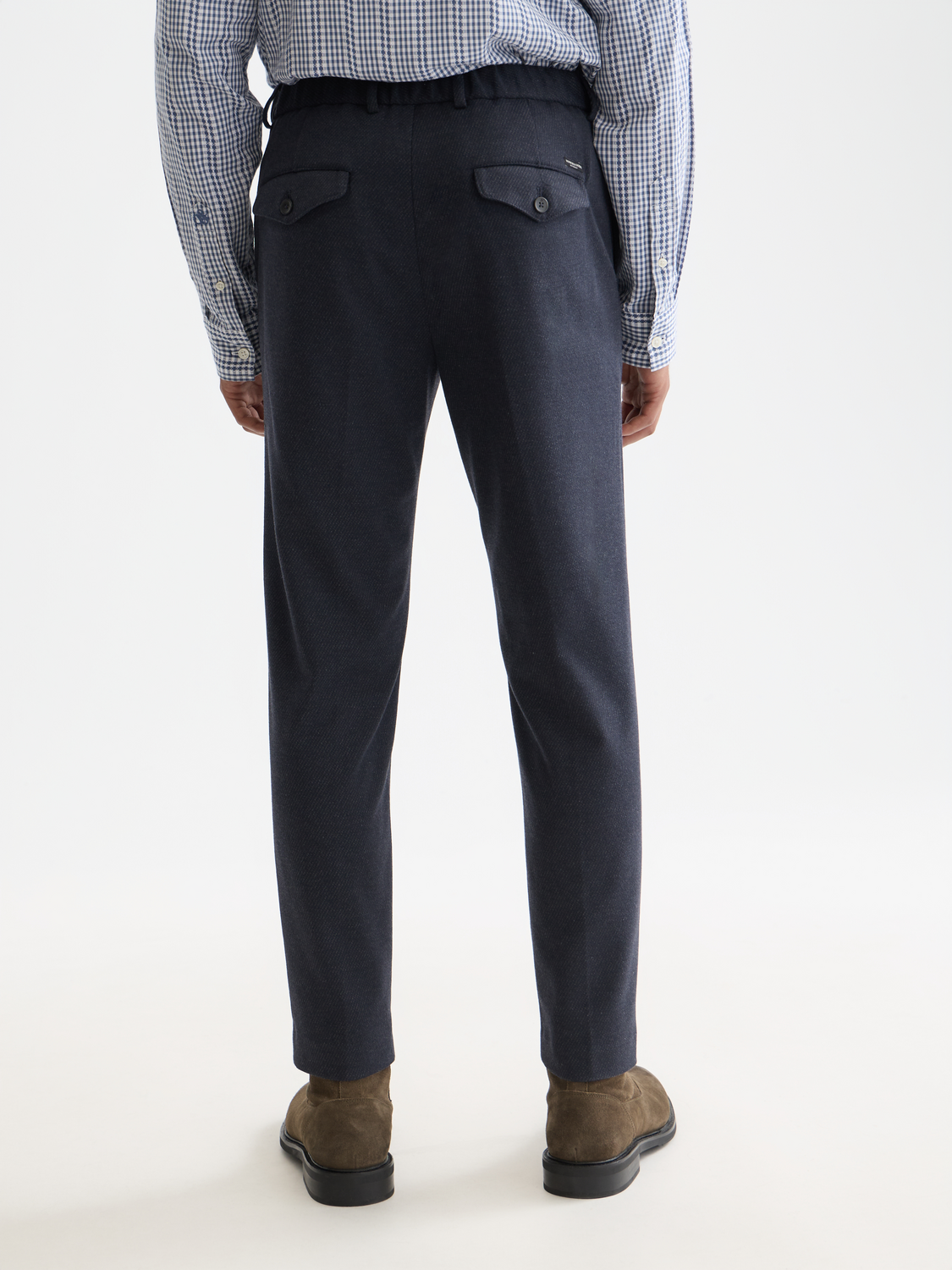 Dark blue Finch tapered-fit pants by Scotch & Soda, showing the back view with tailored design and subtle stitching details.