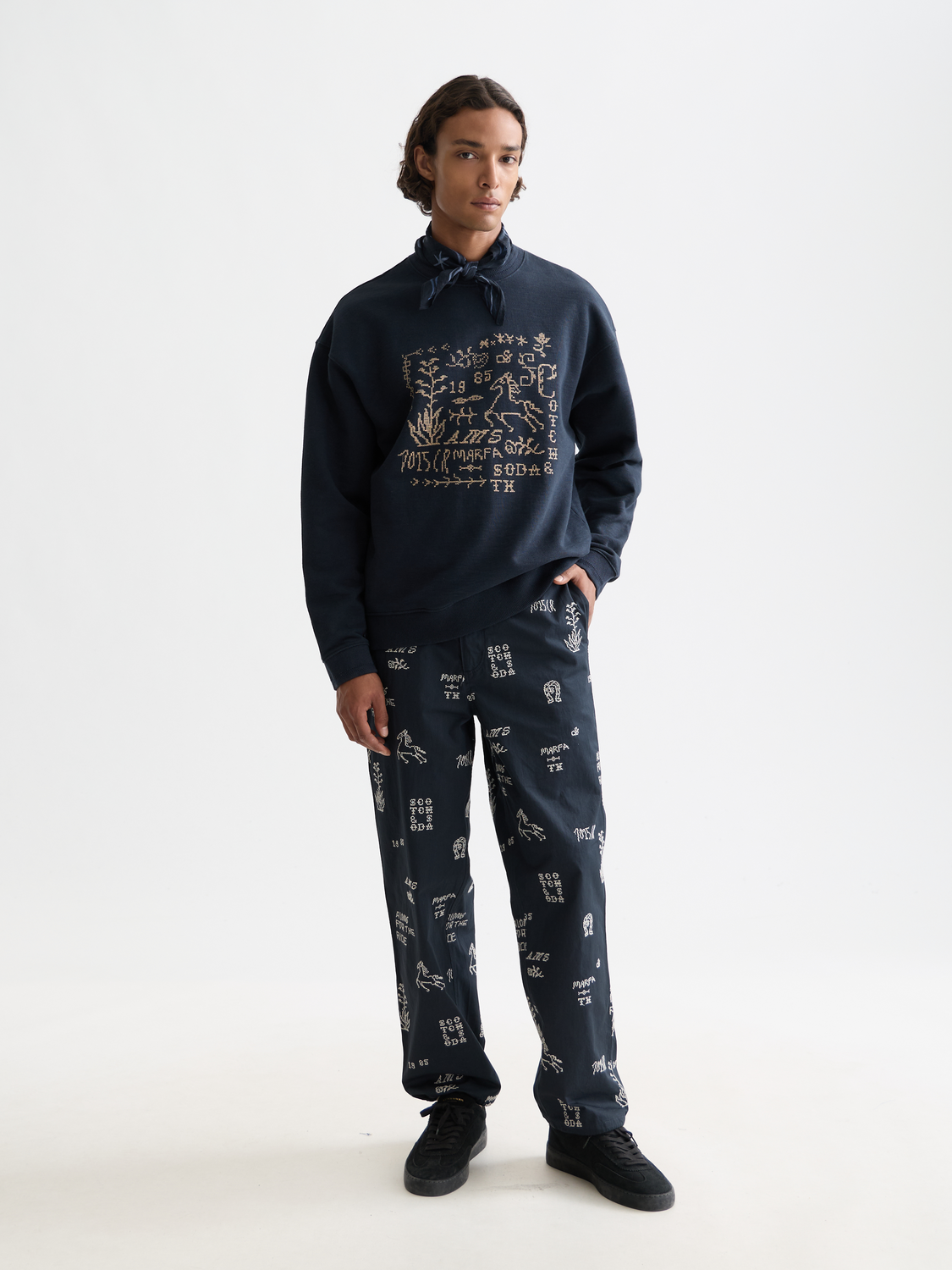 Embroidered beige chinos pants by Scotch & Soda with detailed stitching and classic fit, front view.