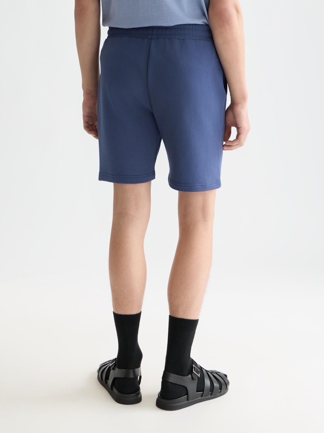 Dark gray logo badge sweatshorts by Scotch & Soda with a back pocket and relaxed fit, casual streetwear style.