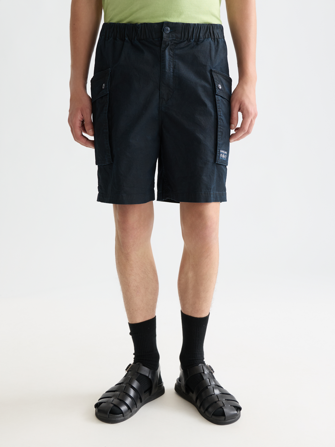 Light brown Scotch & Soda cargo shorts with multiple pockets, casual fit, and belt loops, shown from the front.