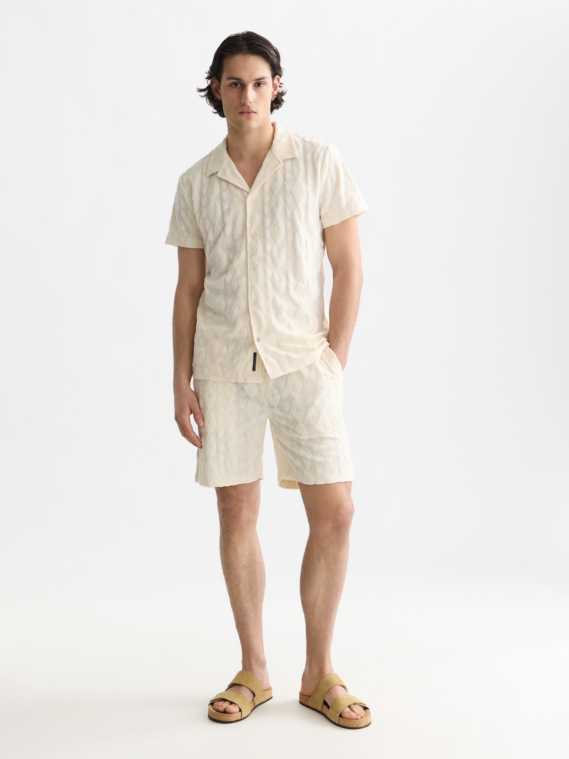 Light beige Scotch & Soda Fave terry shorts with a relaxed fit and elastic waistband, displayed on a model.