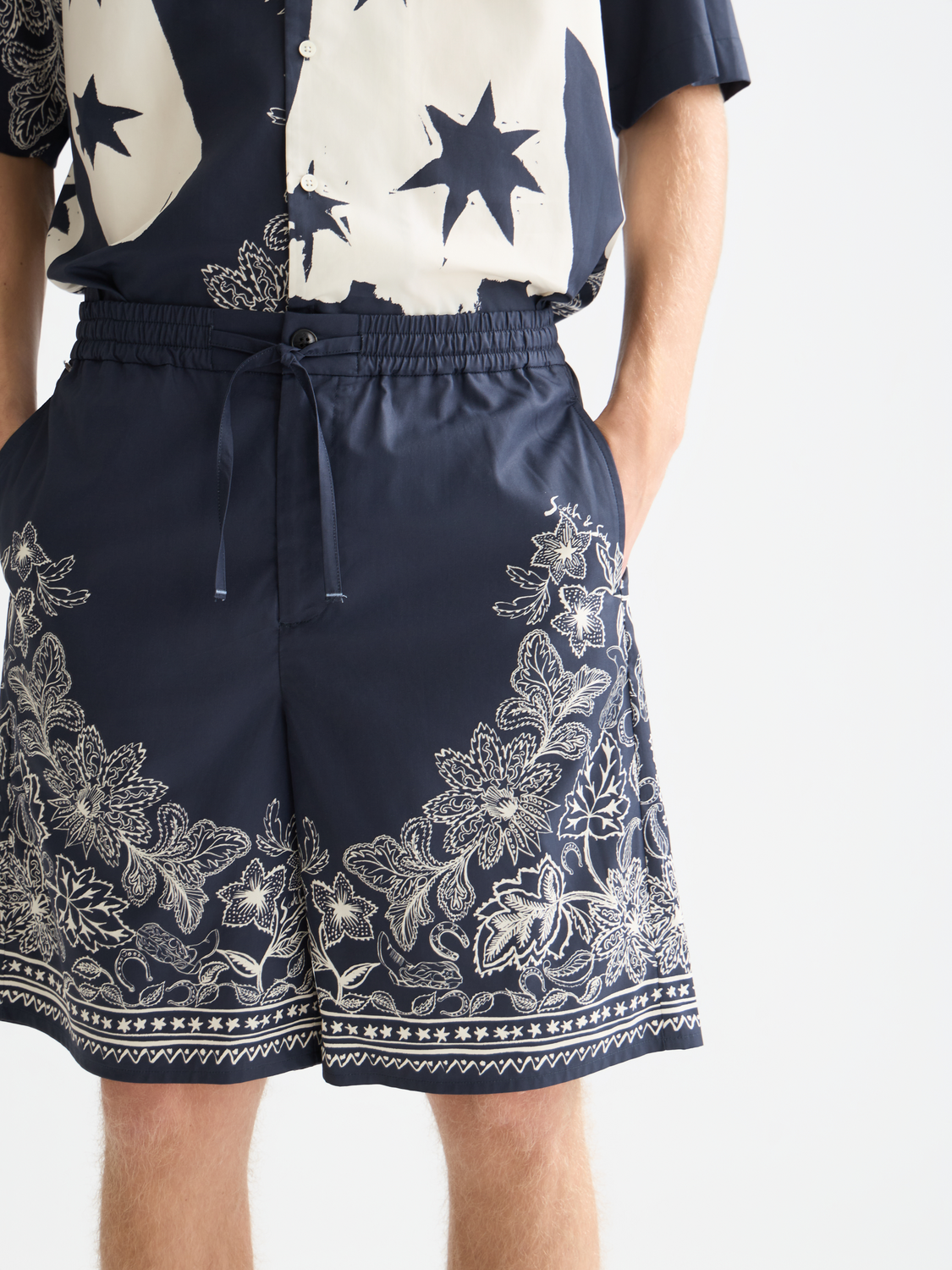 Printed Scotch & Soda shorts featuring colorful floral and geometric patterns, casual fit with a relaxed style.