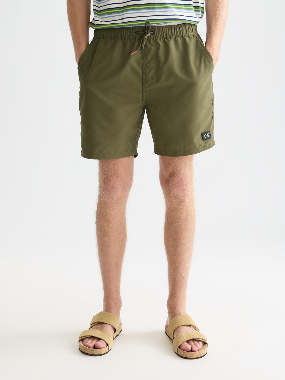 Mid-length Scotch & Soda swim shorts in vibrant coral with a relaxed fit, displayed on a neutral background.