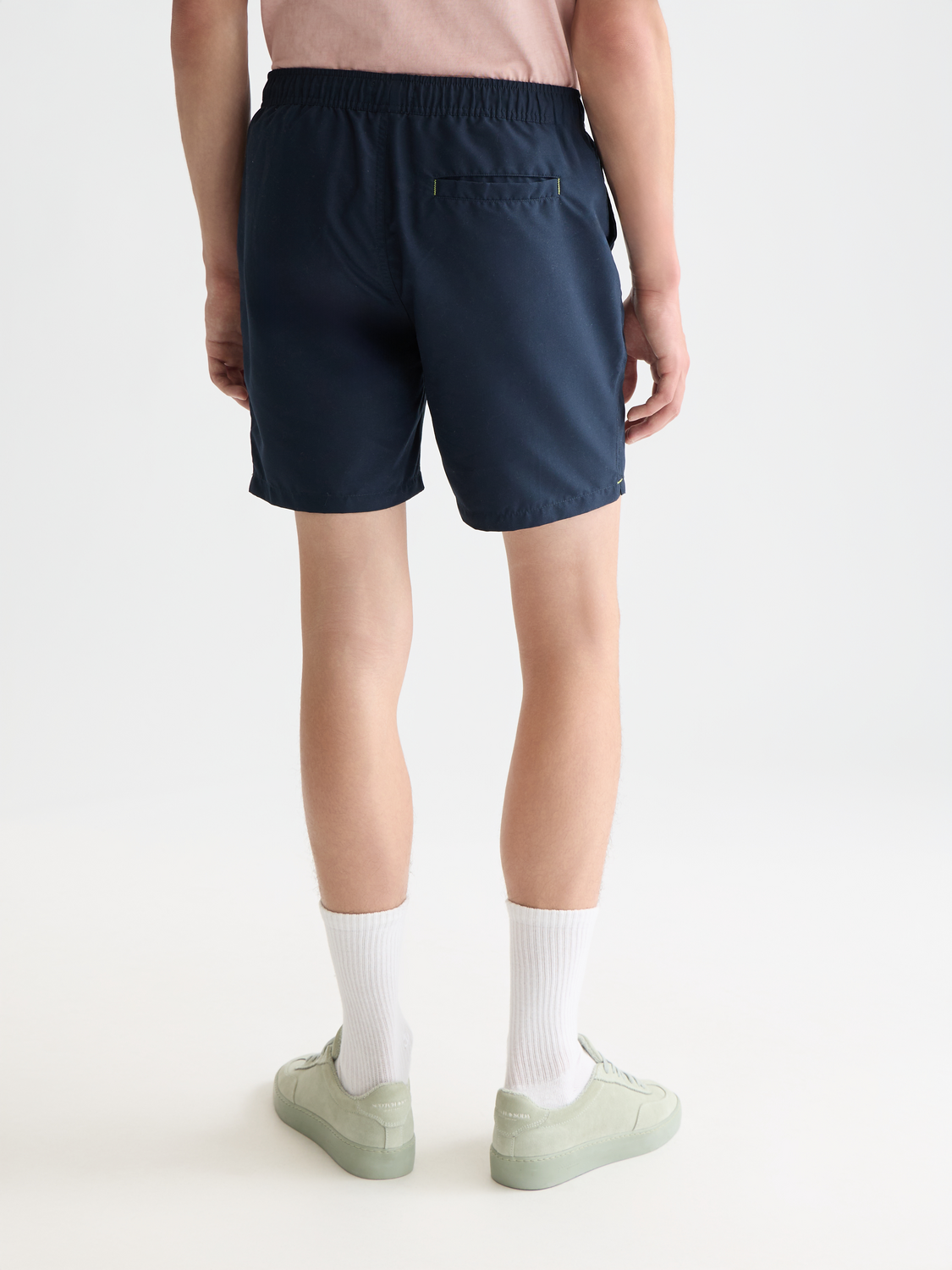 Mid-length SCOTCH & SODA swimshorts in navy with a patterned design, shown from the back.