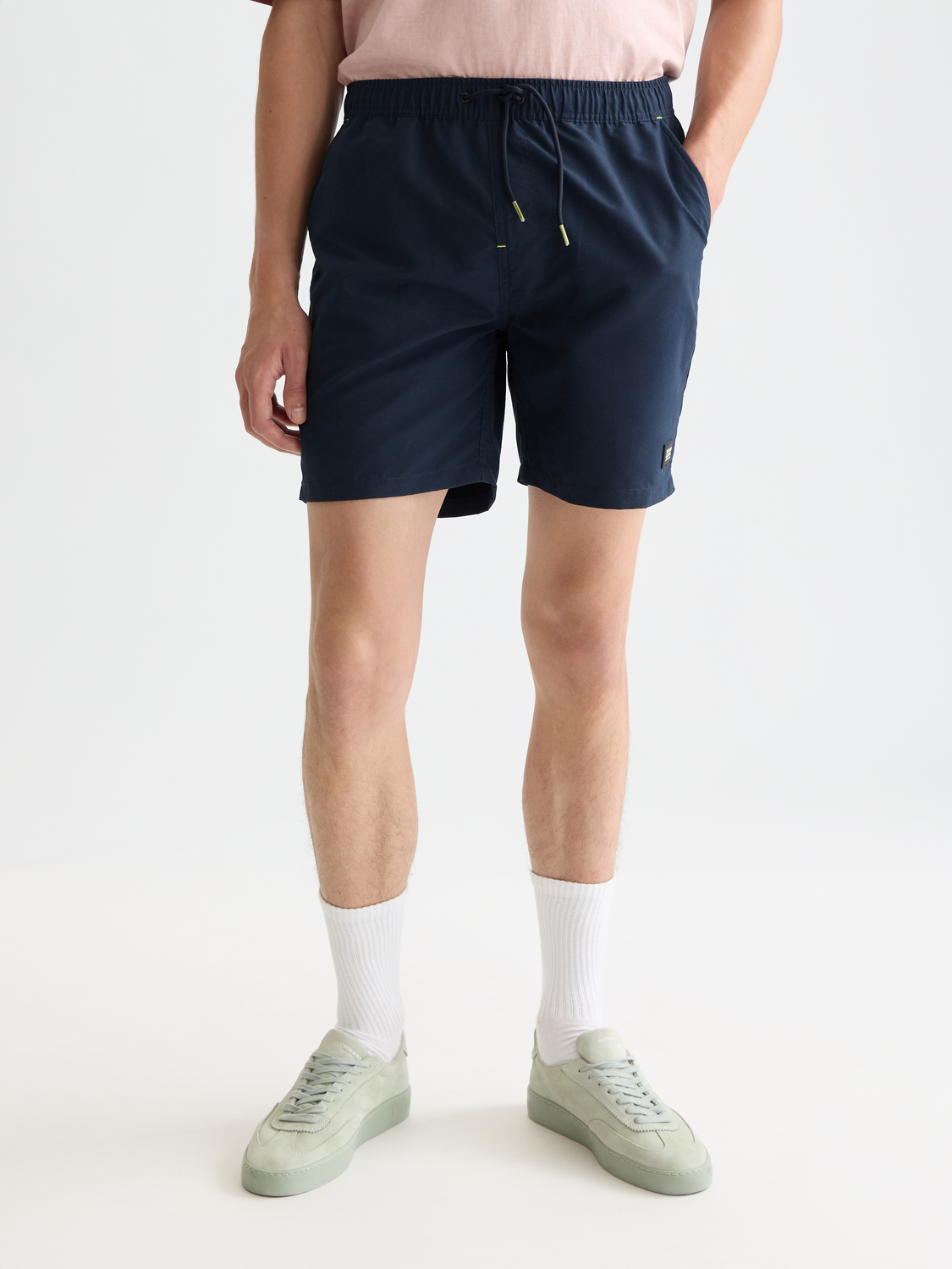 Mid-length Scotch & Soda swim shorts in vibrant print, featuring a drawstring waistband and side pockets.