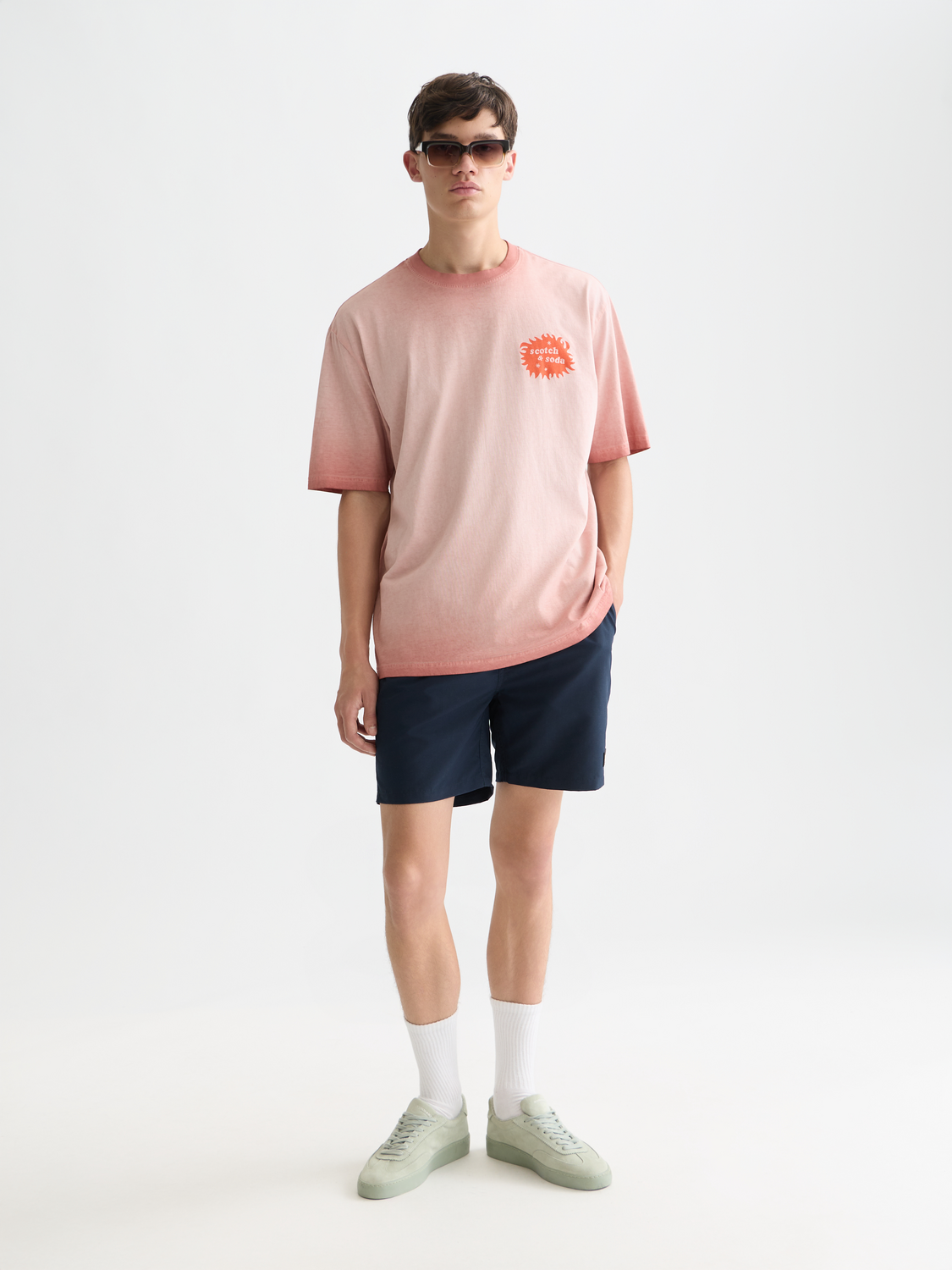 Mid-length Scotch & Soda swim shorts with a colorful pattern, displayed on a model for men's swimwear.
