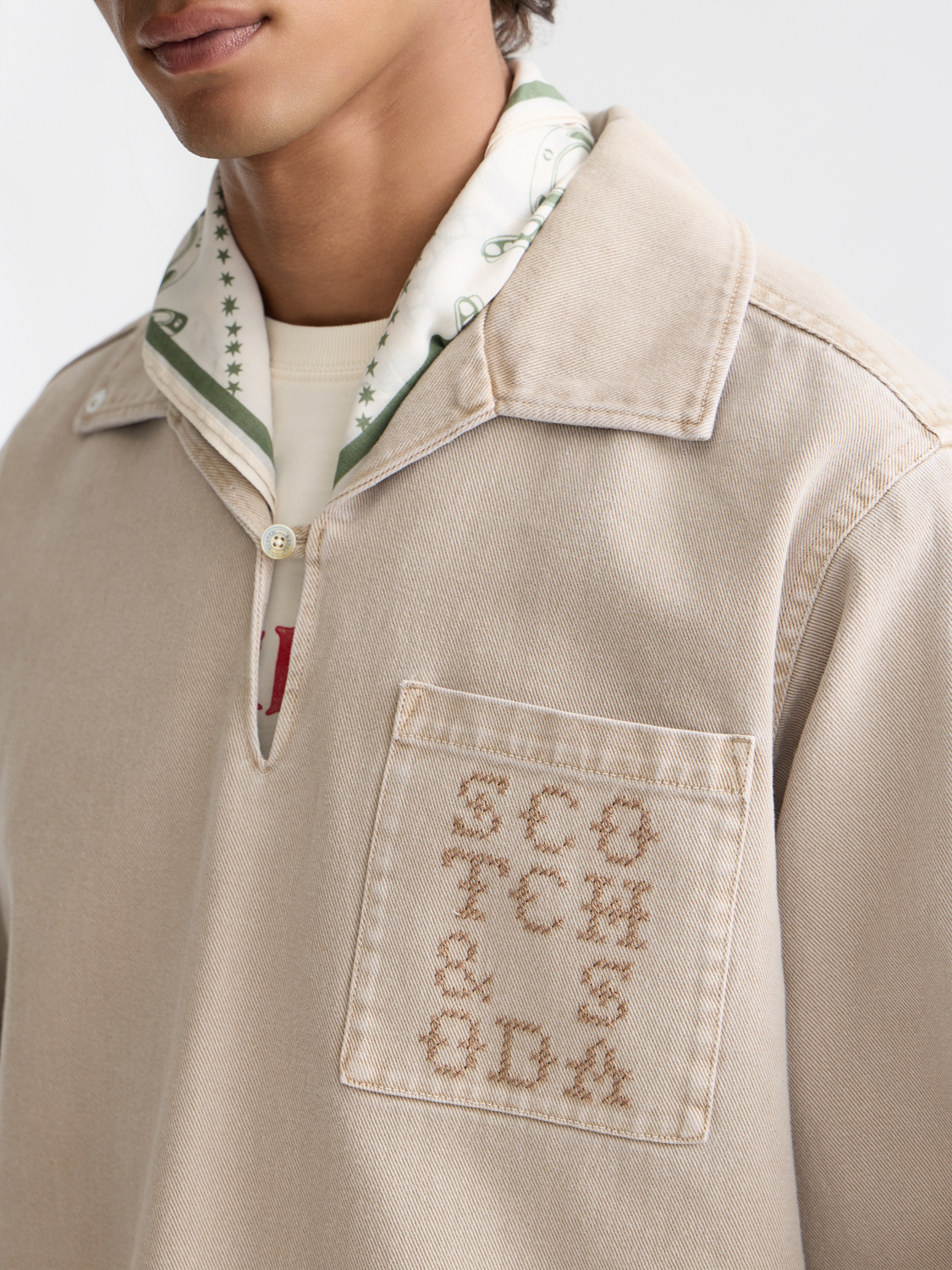 Light washed Scotch & Soda overshirt jacket with a relaxed fit, shown hanging on a wooden hanger.