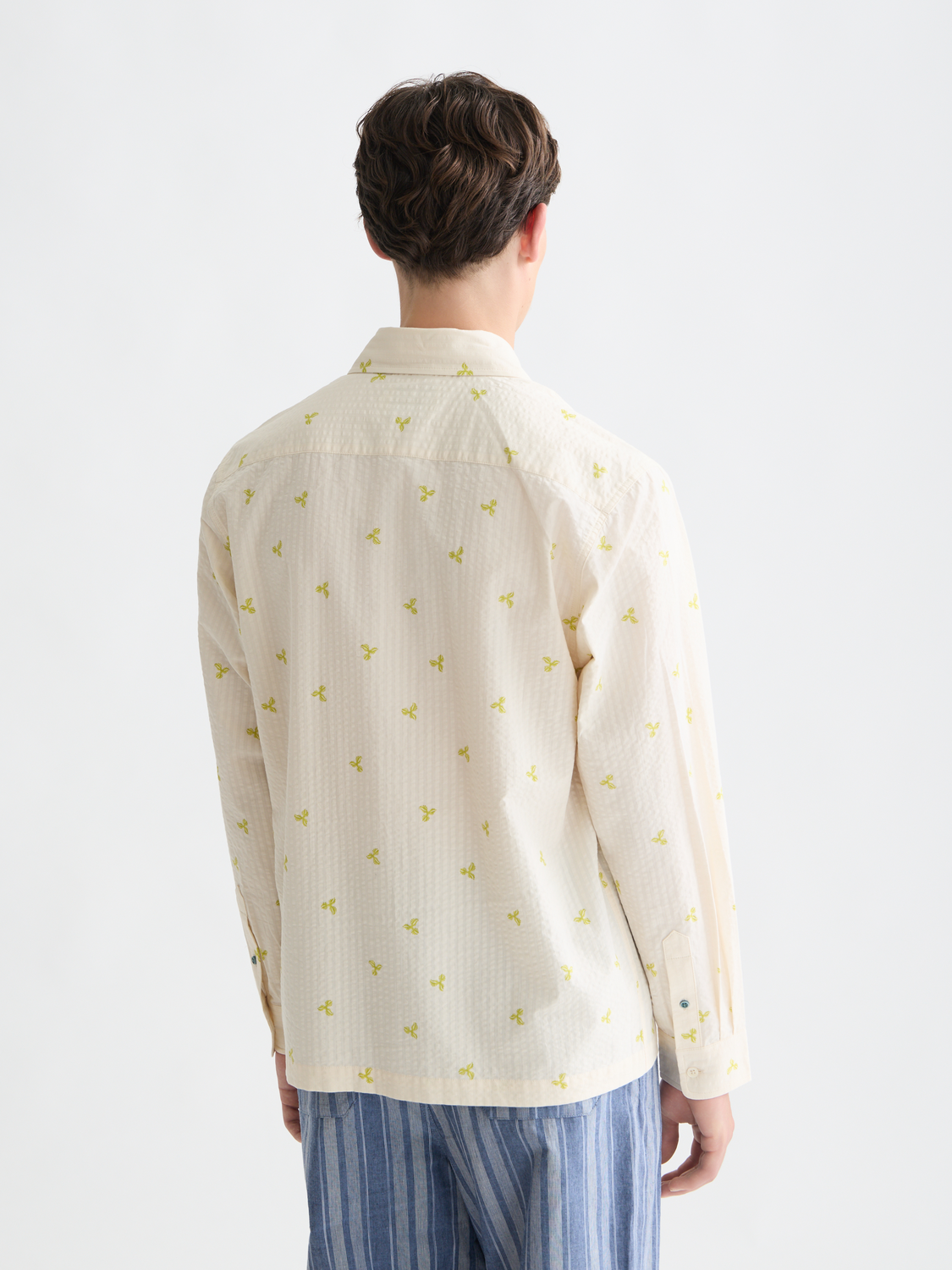 Long sleeve Scotch & Soda seersucker shirt with blue and white striped fabric, displayed from the back.