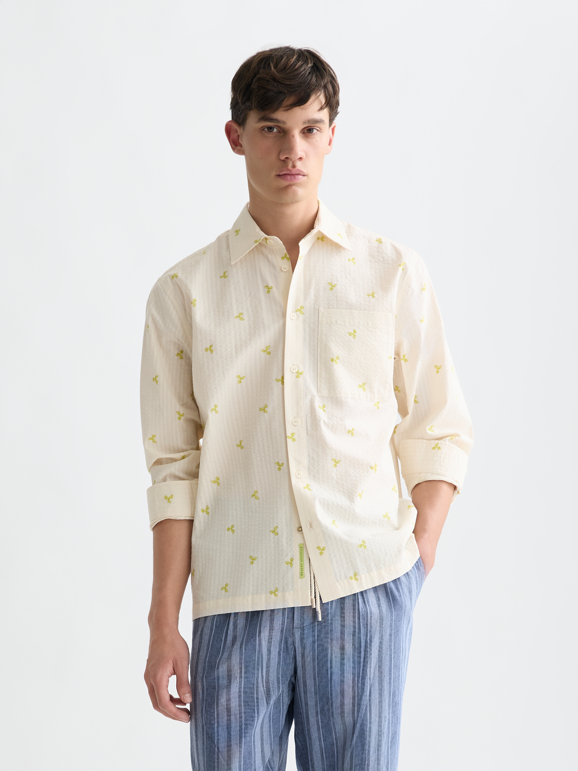 Long-sleeve Scotch & Soda seersucker shirt in light blue with a textured, striped pattern, displayed on a hanger.