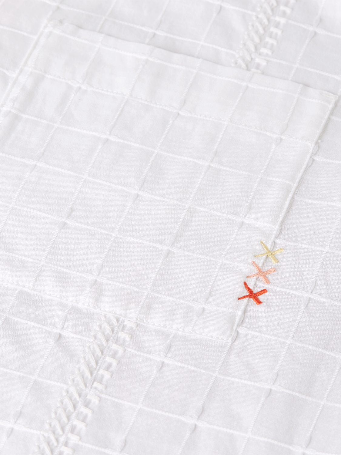 Embroidered short-sleeved shirt from Scotch & Soda with colorful floral embroidery on light fabric.