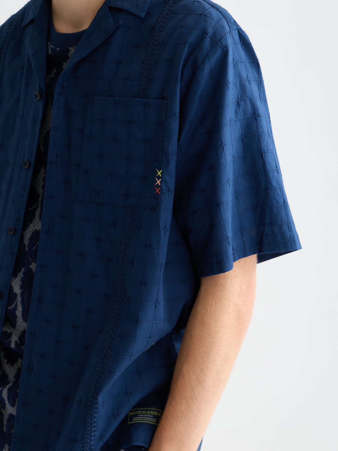 Embroidered short-sleeved SCOTCH & SODA shirt with colorful floral patterns, casual style, on a white background.
