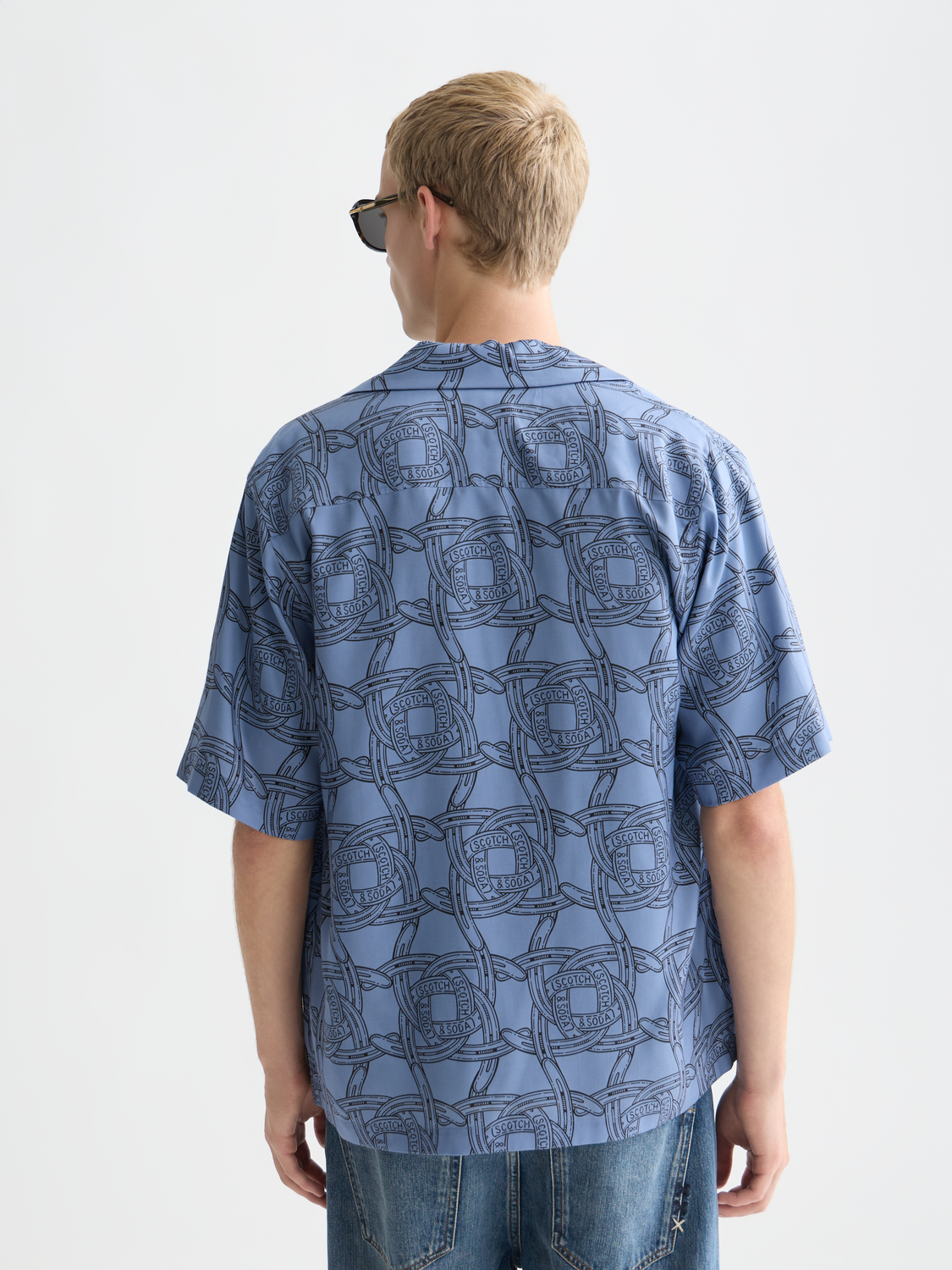 Printed short-sleeved shirt by Scotch & Soda featuring a stylish design, shown from the back with vibrant colors and pattern.