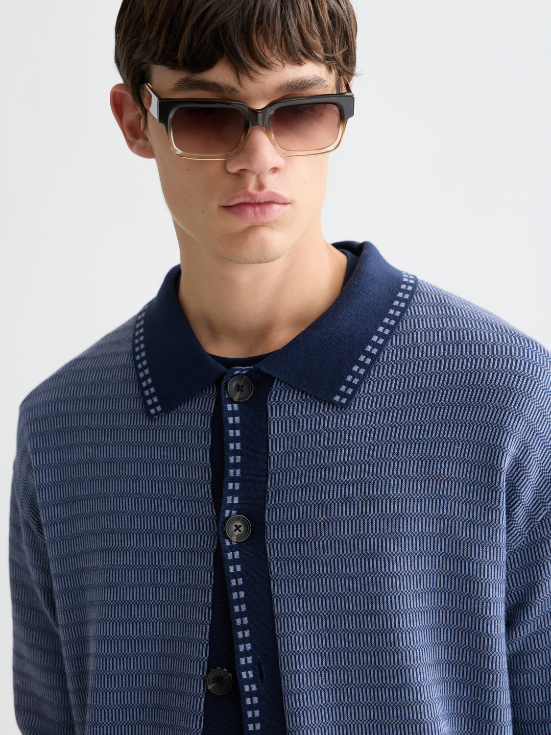 SCOTCH & SODA polo cardigan knitwear in navy with button details and ribbed cuffs, laid flat for display.