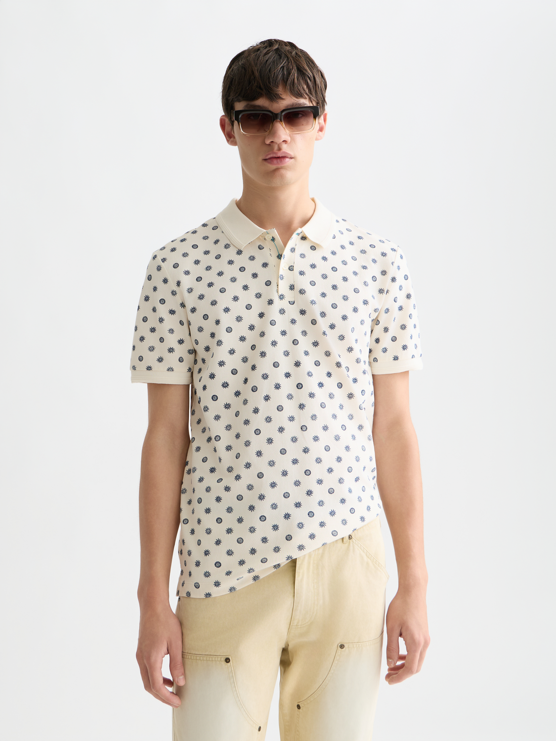 Printed Scotch & Soda polo shirt with colorful pattern and classic collar, displayed on a plain background.