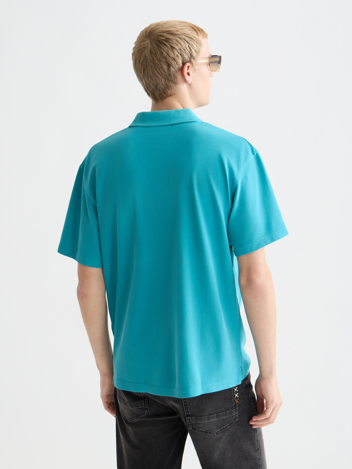 Navy Scotch & Soda pique polo shirt with a classic collar and short sleeves, shown from the back.