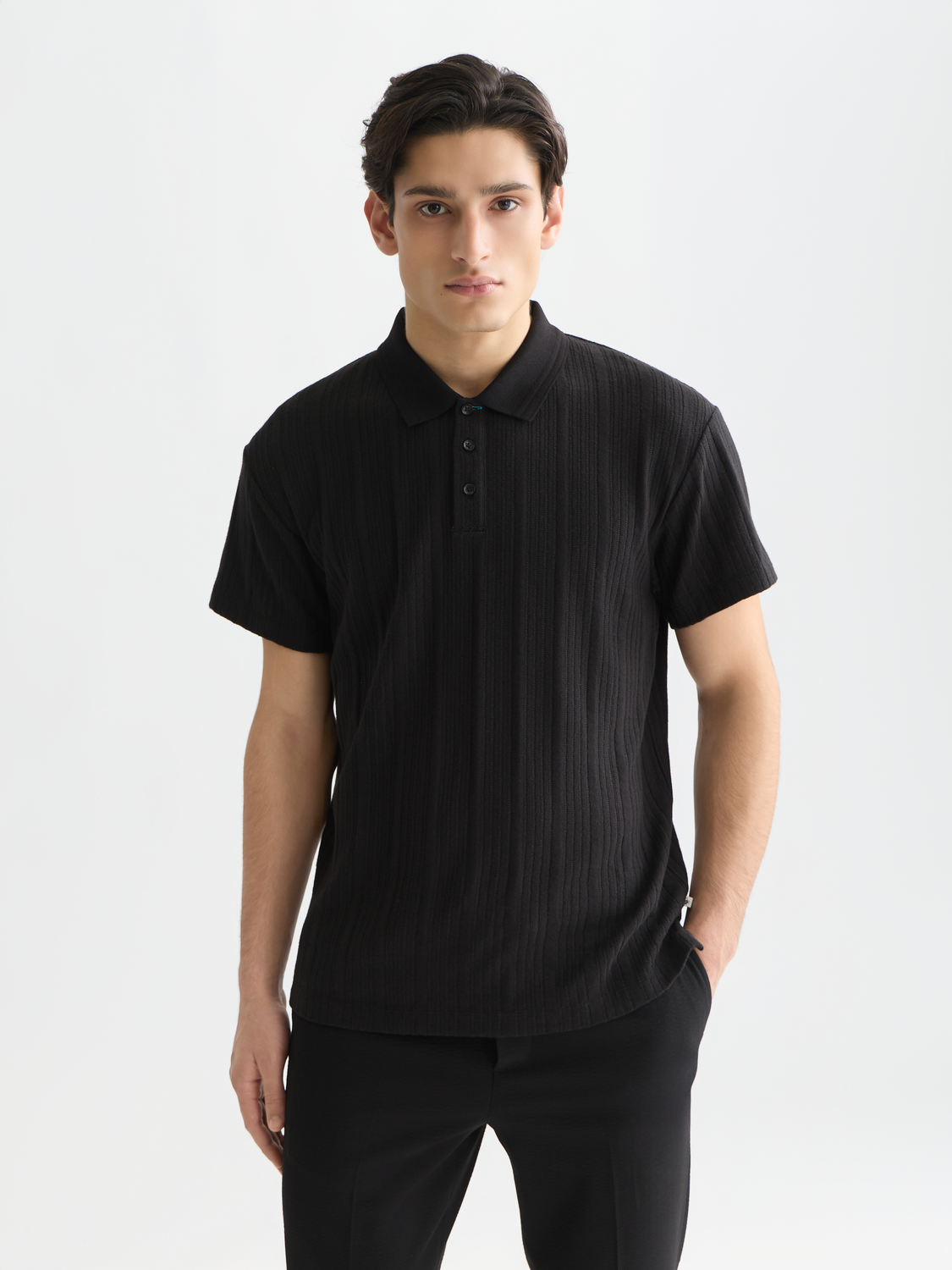 Navy ribbed polo shirt from Scotch & Soda, featuring a classic collar and short sleeves, displayed flat on a white background.
