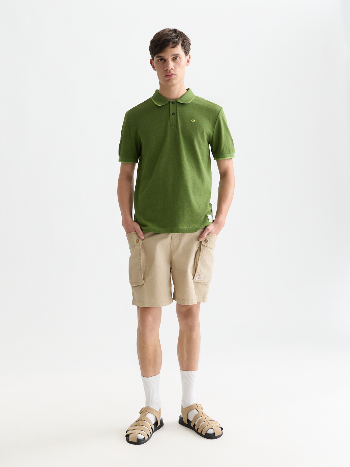 Navy melange polo shirt by Scotch & Soda with a classic collar and short sleeves, displayed on a white background.