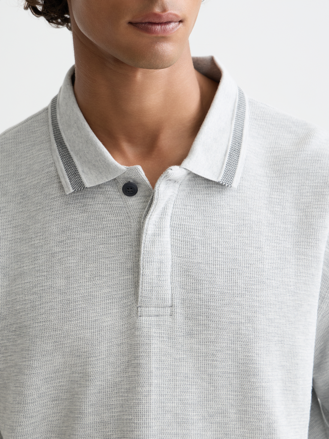 Long-sleeved SCOTCH & SODA polo shirt in navy with a classic collar and button placket, displayed on a white background.