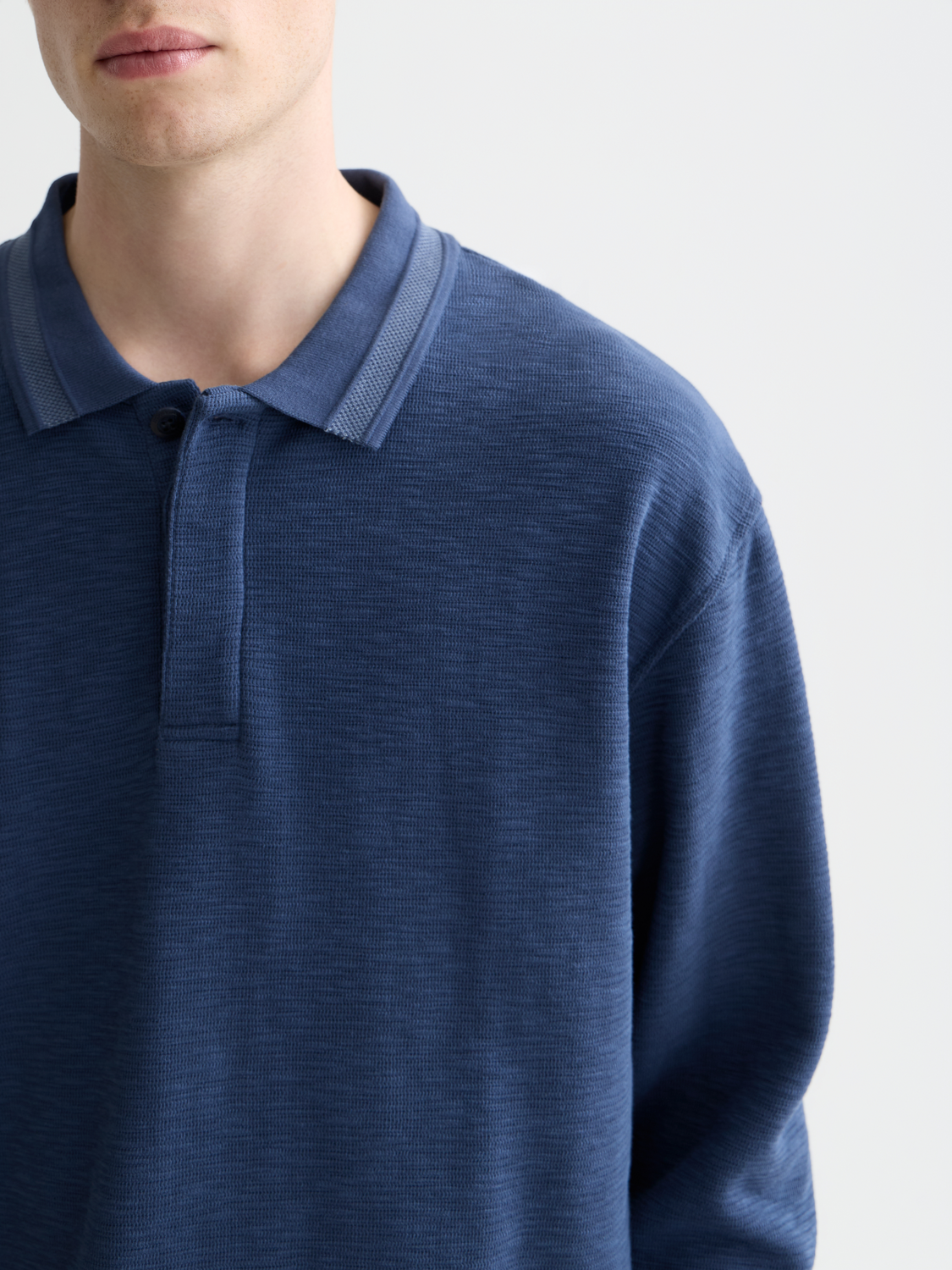 Long-sleeved polo shirt by Scotch & Soda in navy blue with a classic collar and button placket.
