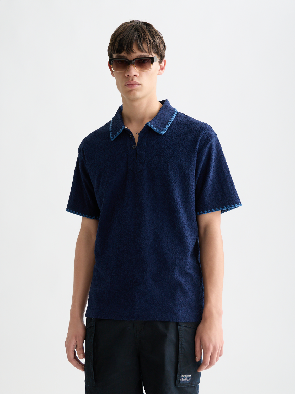Scotch & Soda jacquard towelling polo shirt in coral color, featuring a classic polo collar and textured fabric.