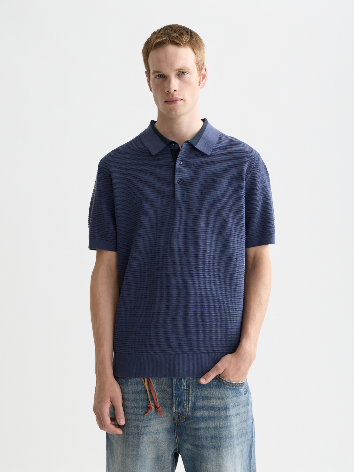 Structured knit polo shirt by Scotch & Soda featuring a classic collar and textured fabric in a vibrant color.