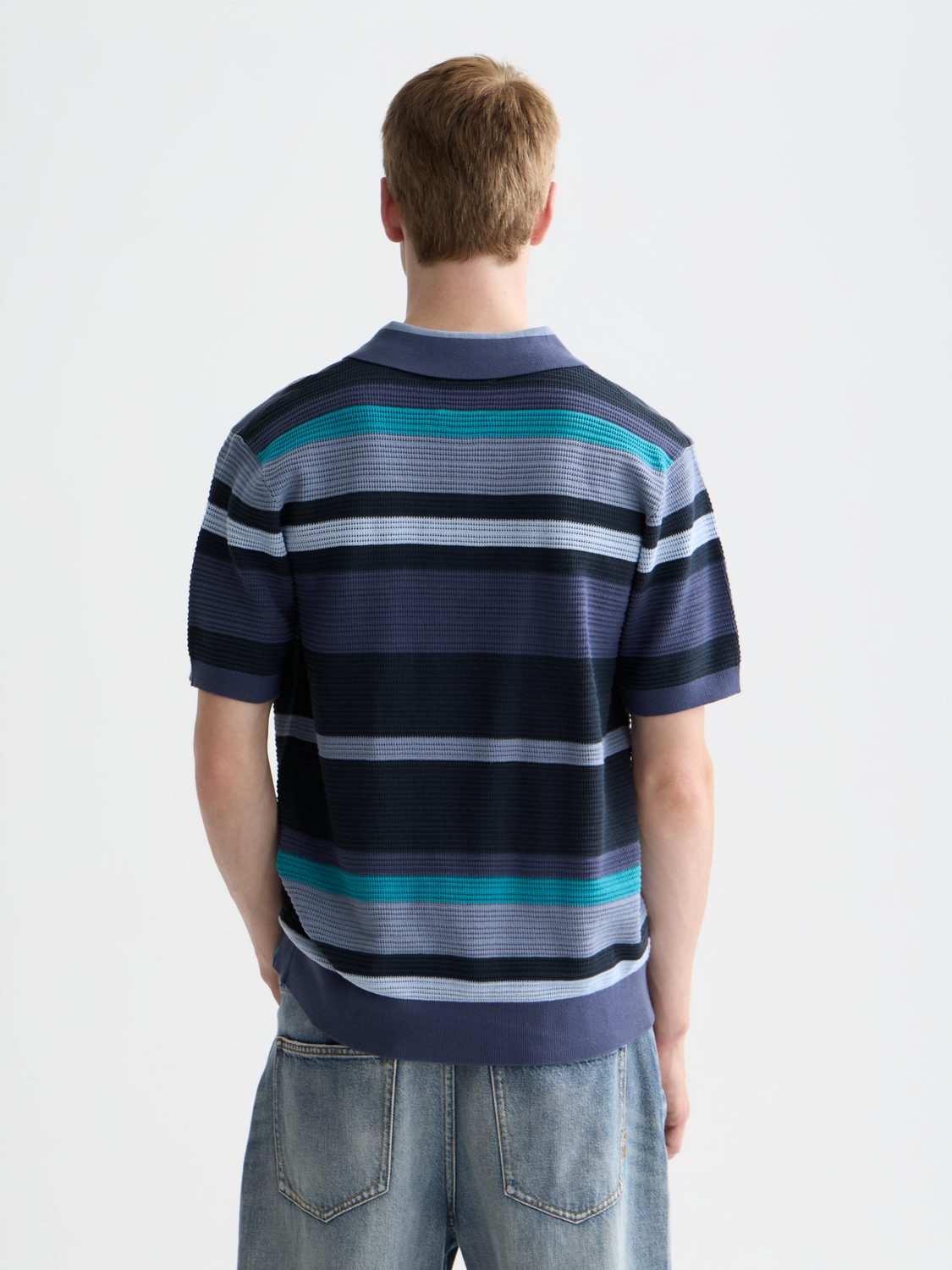 Blue knitted polo shirt by Scotch & Soda, featuring a classic collar and textured knit fabric.