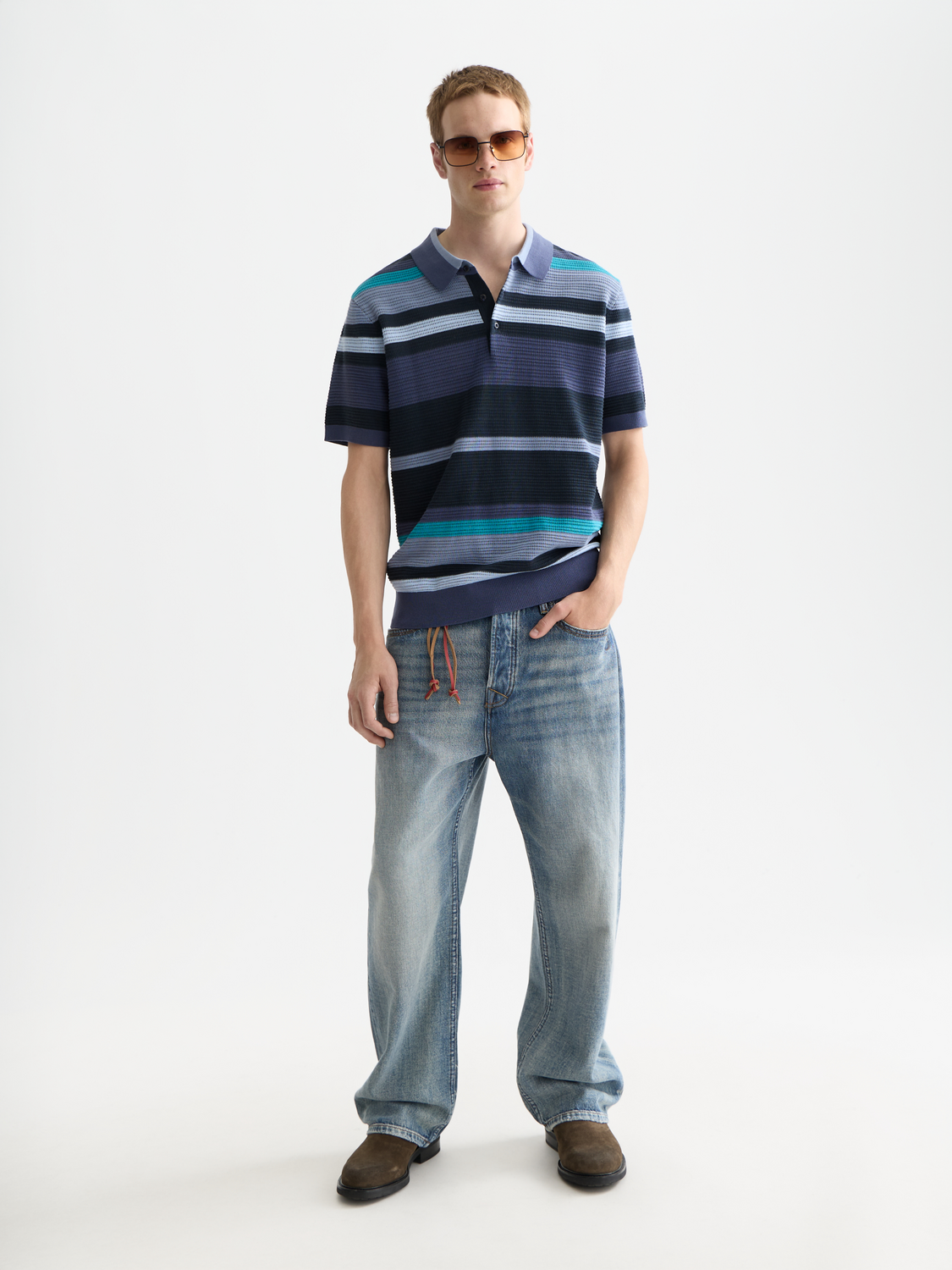 Navy knitted polo shirt by Scotch & Soda with a classic collar and short sleeves, displayed on a neutral background.