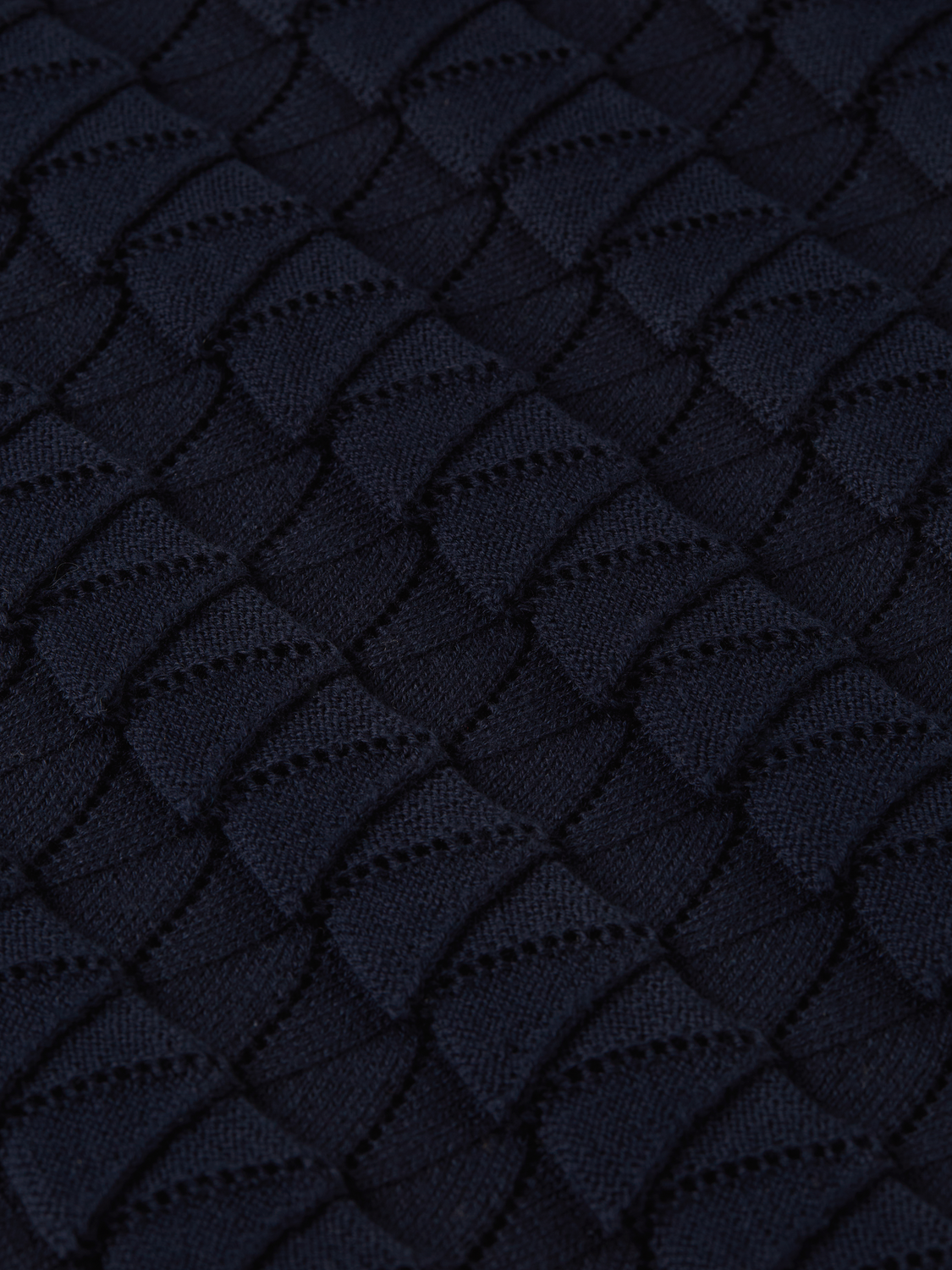 Knitted polo shirt by Scotch & Soda featuring a classic collar and textured knit fabric, displayed on a neutral background.