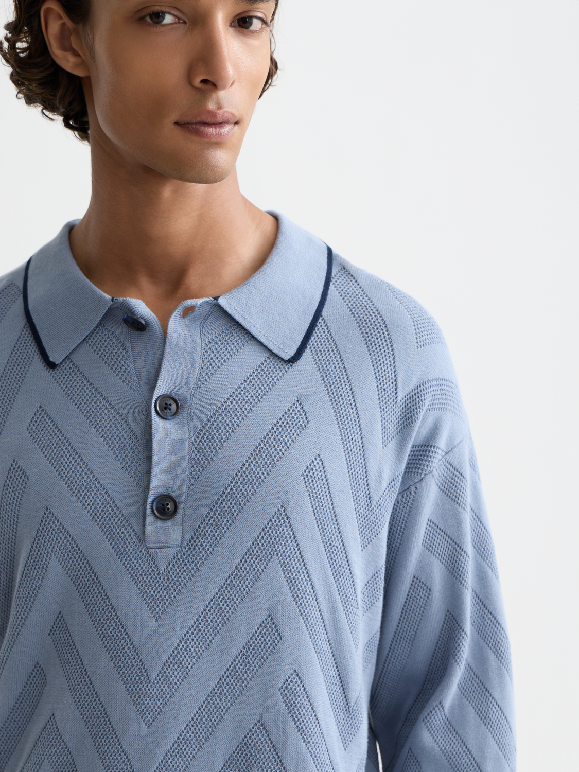 Long-sleeved Scotch & Soda polo shirt in a classic design, featuring a collar and button placket, displayed on a mannequin.