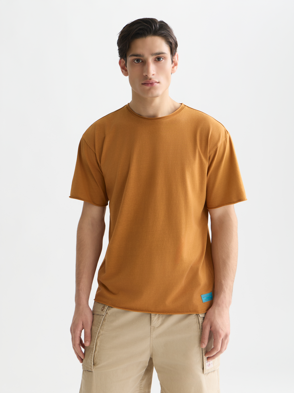 Raw edge Scotch & Soda short sleeve T-shirt with a casual fit, displayed on a hanger with a neutral background.