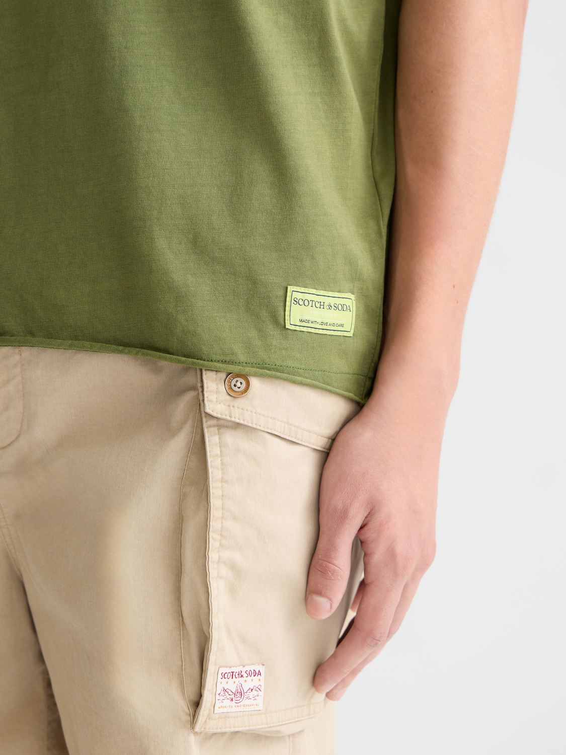 Light gray Scotch & Soda raw edge short sleeve t-shirt with a casual, relaxed fit and distressed neckline.
