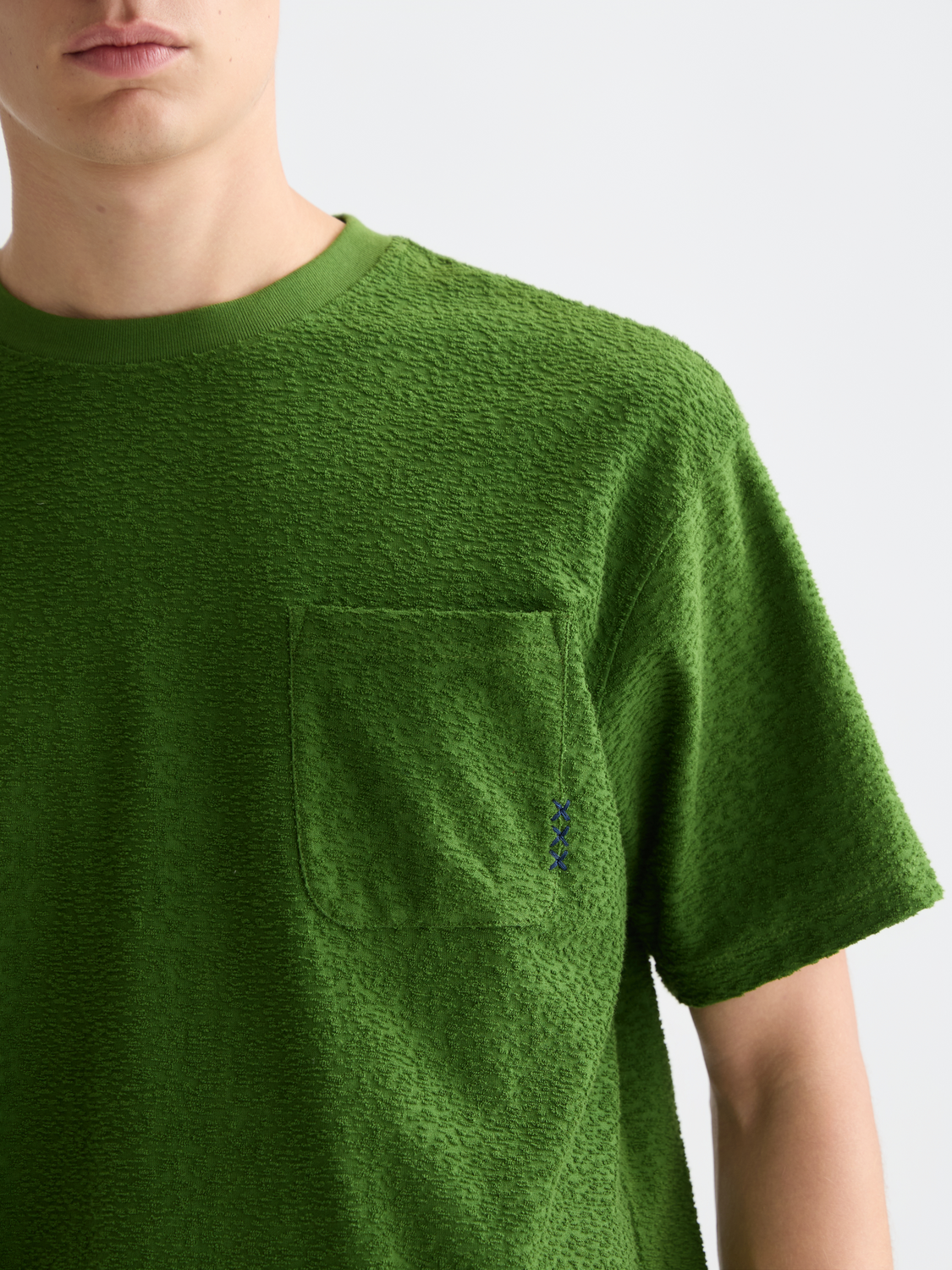 Jacquard towelling Scotch & Soda short-sleeve T-shirt displayed on a hanger, showcasing textured fabric and classic fit.