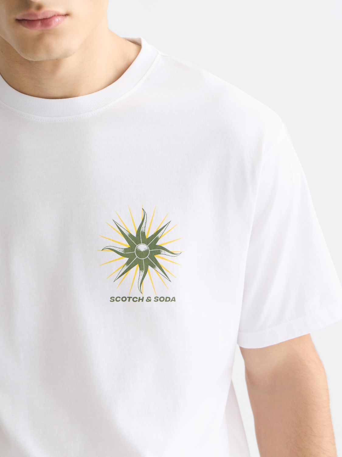 Scotch & Soda short-sleeve artwork t-shirt with colorful graphic design on white cotton fabric.