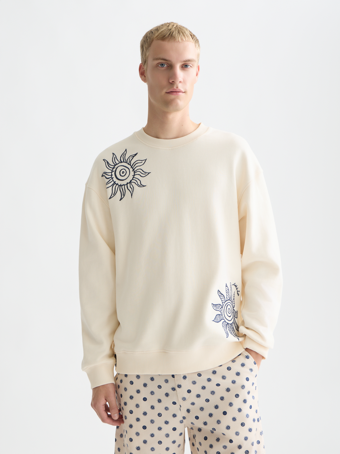 Embroidered Scotch & Soda sweatshirt with colorful floral design, relaxed fit, and soft cotton fabric, displayed on a hanger.