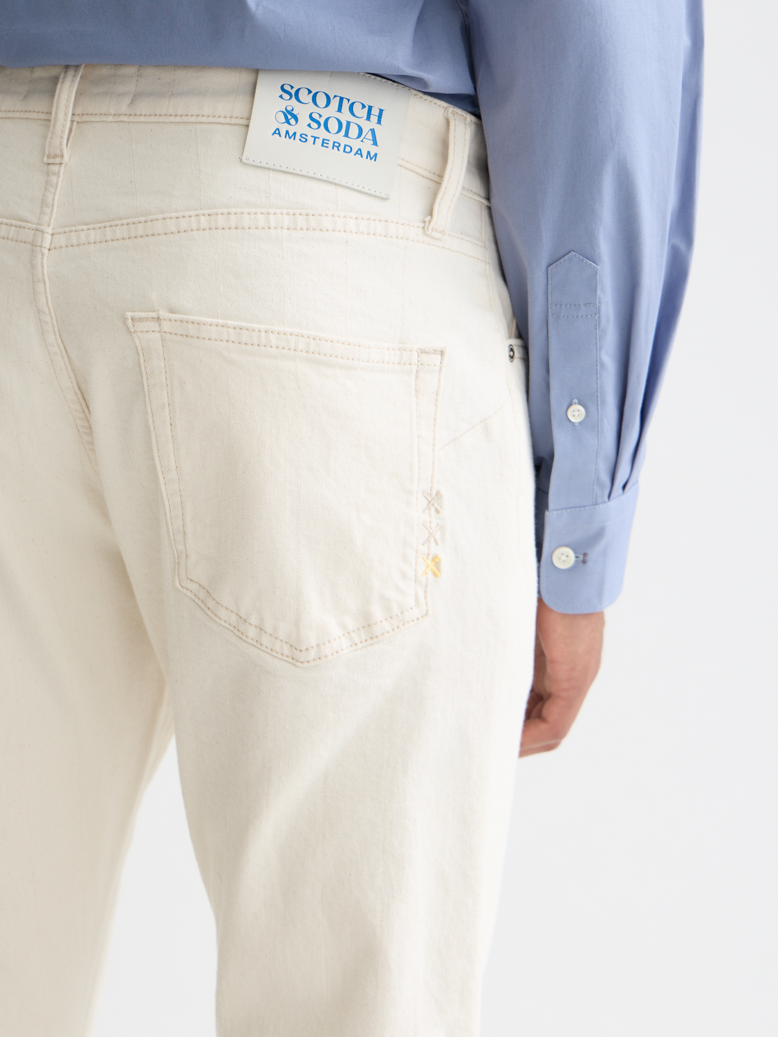SCOTCH & SODA Zee straight-fit denim jeans with classic five-pocket design and light wash, shown laid flat.