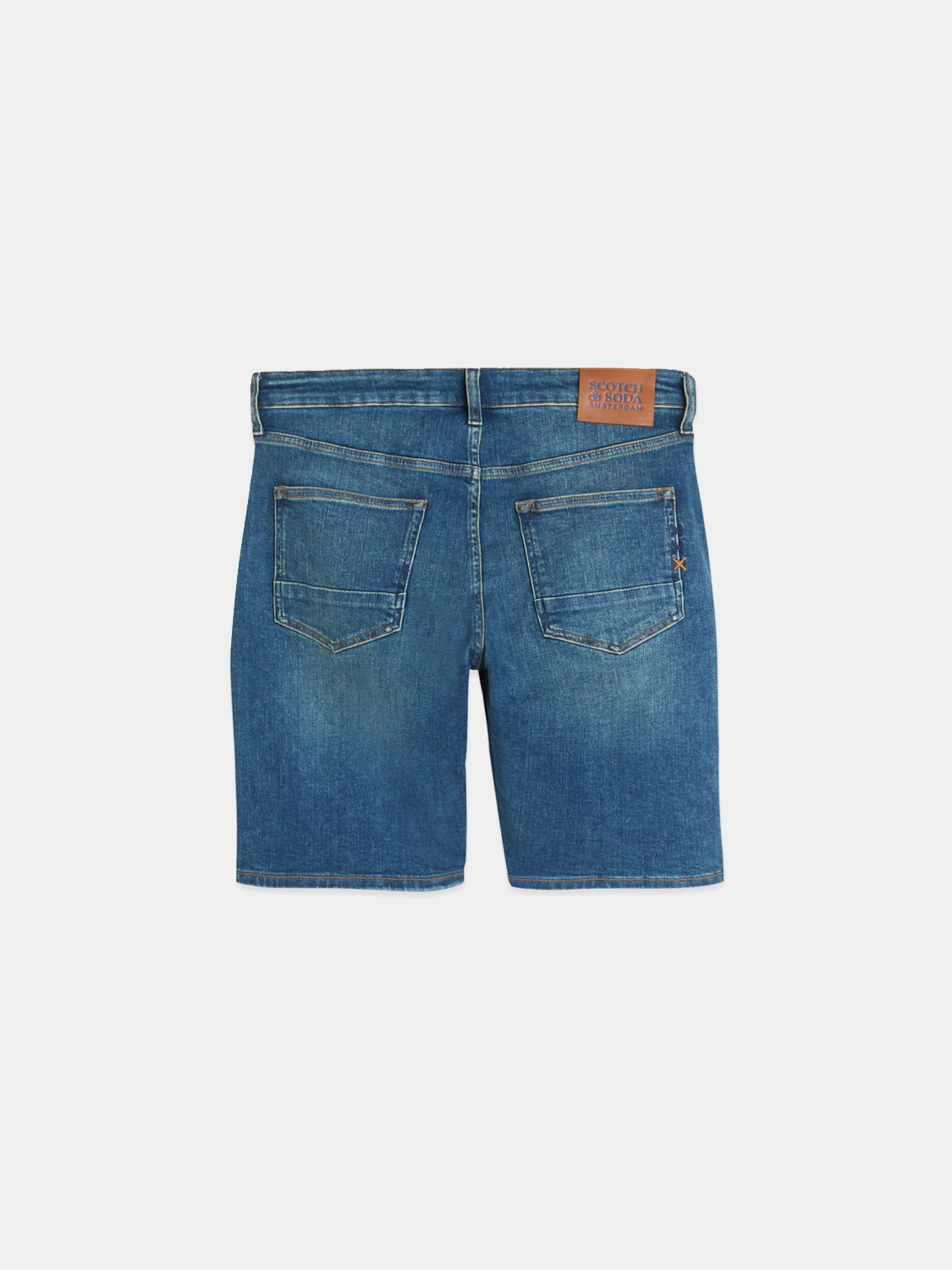 Black Ralston denim shorts by Scotch & Soda with distressed details and frayed hem, styled on a hanger against a white background.