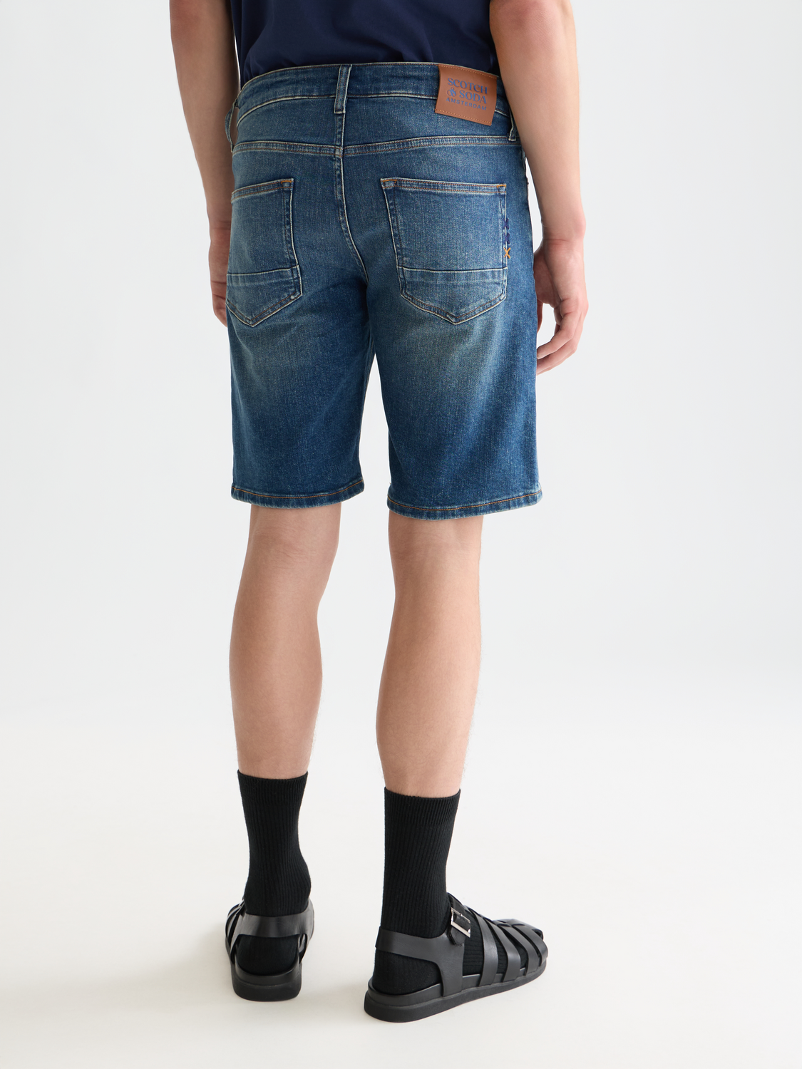 SCOTCH & SODA Ralston denim shorts showing back view with distressed details and classic five-pocket design.
